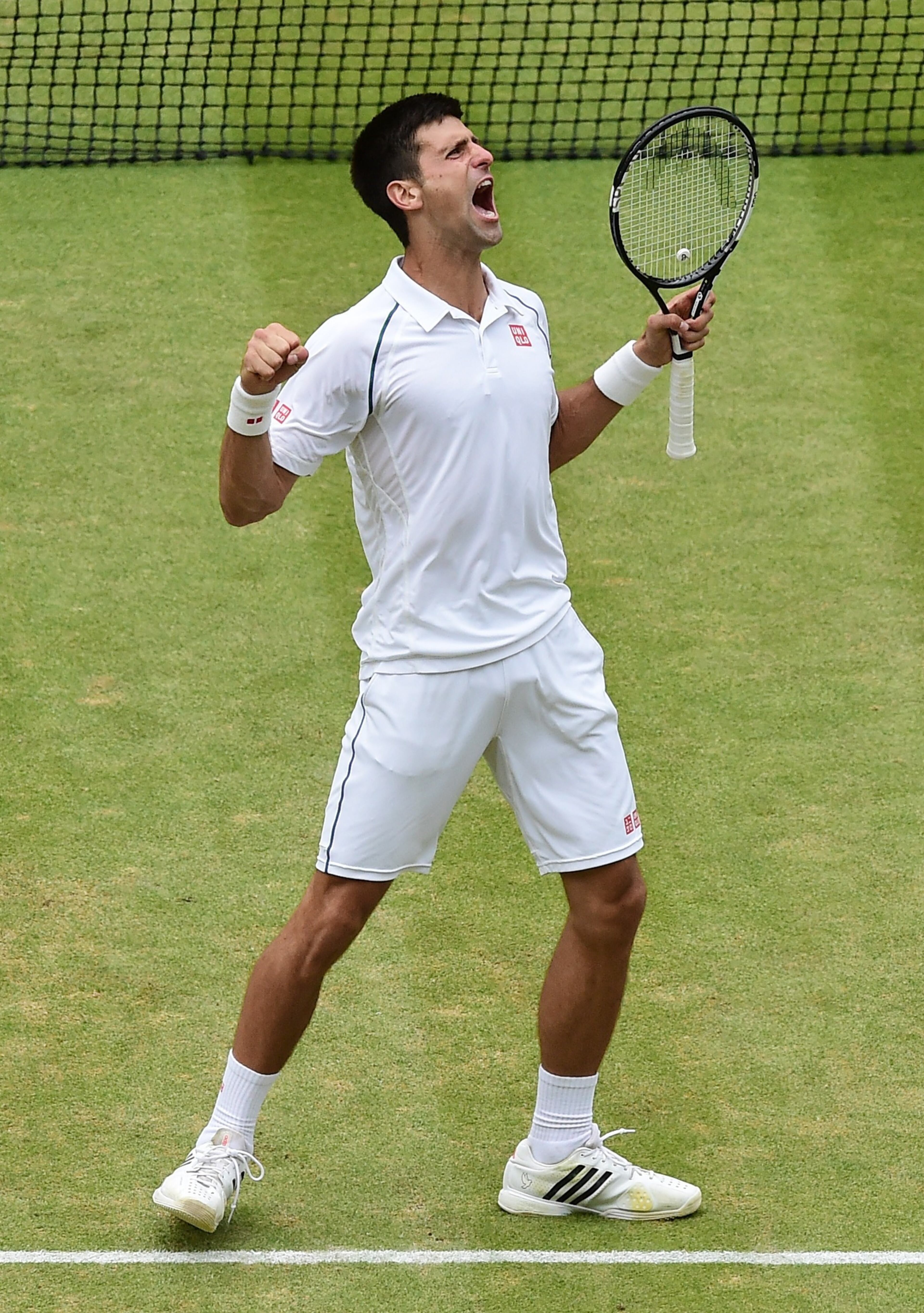 LONDON, ENGLAND - JULY 12: Novak Djokovic celebrates with the trophy after victory over Roger Federer of Switzerland in the Gentleman's Singles Final during day thirteen of the Wimbledon Lawn Tennis Championships at the All England Lawn Tennis and Croquet Club on July 12, 2015 in London, England. (Photo by Alex Broadway/Anadolu Agency/Getty Images)