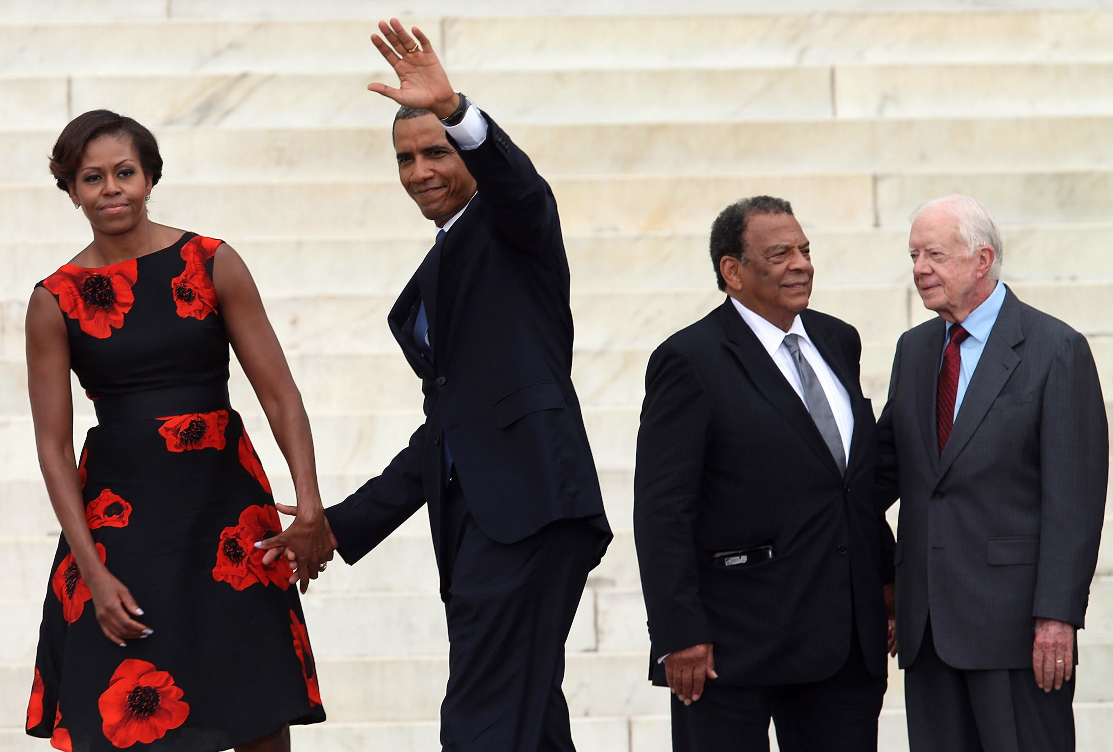 WASHINGTON, DC - AUGUST 28: President Barack Obama (2nd-L) and his wife Michelle Obama hold hands as former U.S. President Jimmy Carter (R) and Andrew Young stand nearby during the ceremony to commemorate the 50th anniversary of the March on Washington for Jobs and Freedom August 28, 2013 in Washington, DC. It was 50 years ago today that Martin Luther King, Jr. delivered his "I Have A Dream Speech" on the steps of the Lincoln Memorial. (Photo by Mark Wilson/Getty Images)