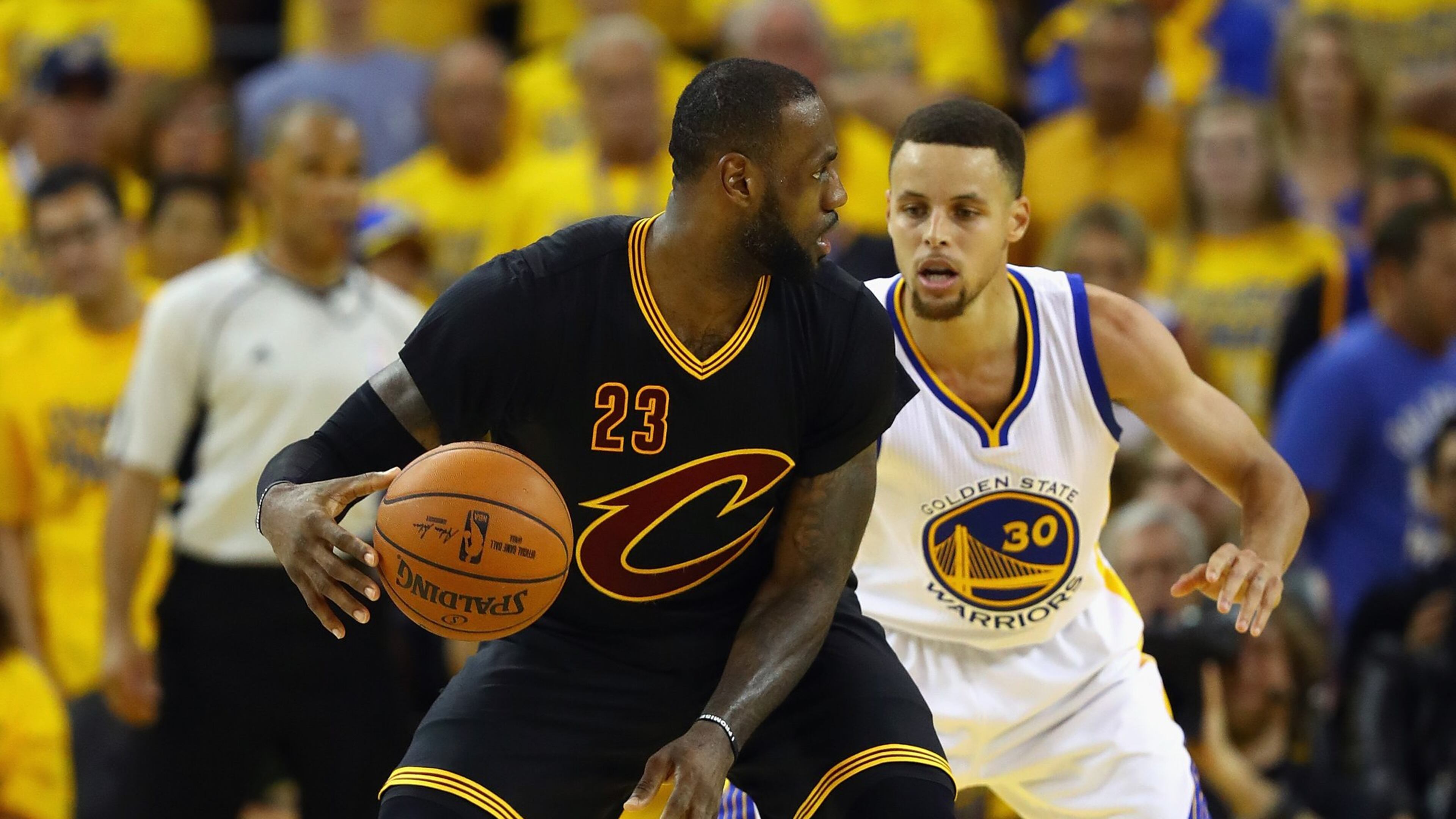 LeBron James of the Cleveland Cavaliers handles the ball against Stephen Curry of the Golden State Warriors during the second half in Game 7 of the 2016 NBA Finals at Oracle Arena on June 19, 2016 in Oakland, California. (Photo by Ezra Shaw/Getty Images)