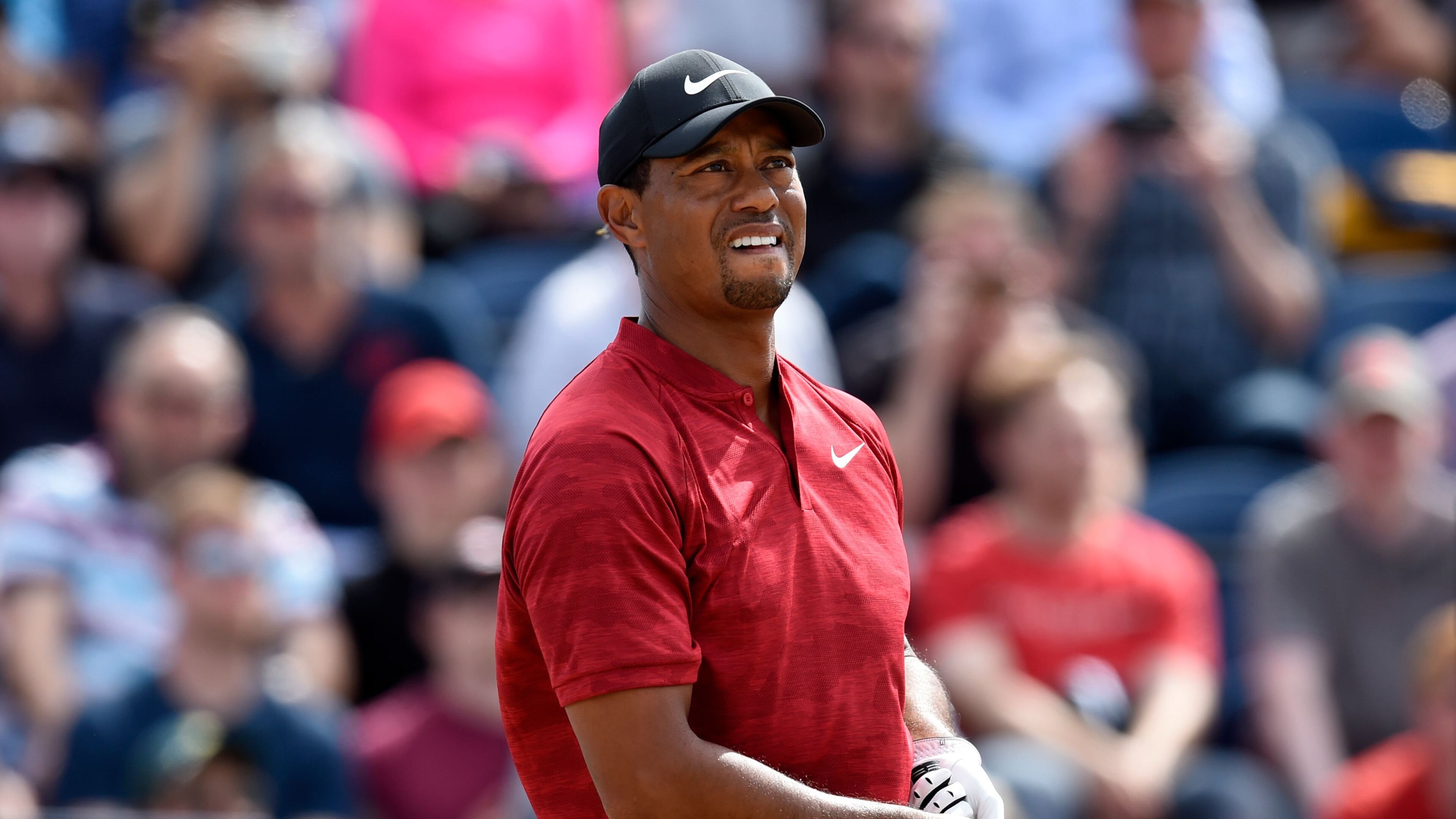 Tiger Woods reacts after playing his shot from the third tee during the final round of The Open Championship golf tournament at Carnoustie Golf Links.