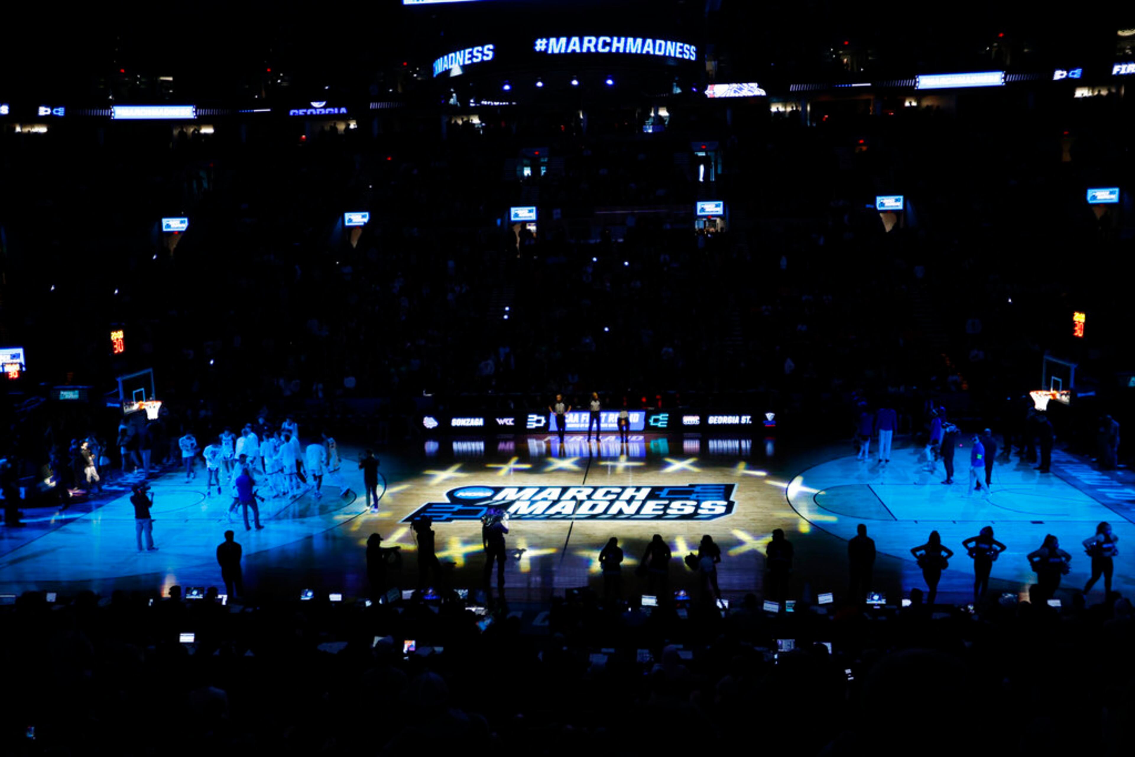 Players from Gonzaga and Georgia State stand on the court before a first round NCAA college basketball tournament game Thursday, March 17, 2022, at the Moda Center in Portland, Ore. (AP Photo/Craig Mitchelldyer)
