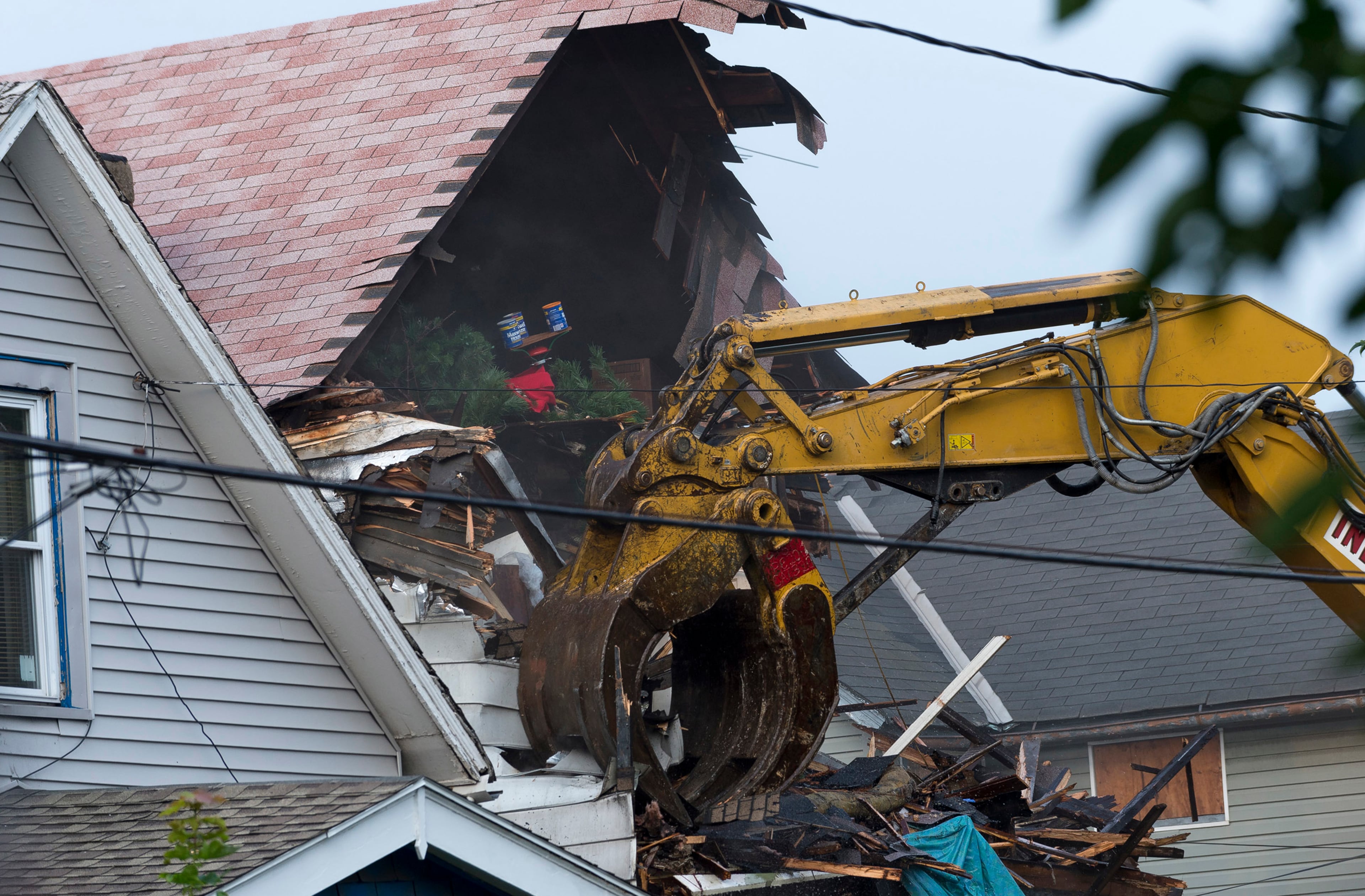 A crane demolishes the home of Ariel Castro on Aug. 7, 2013, in Cleveland, Ohio.