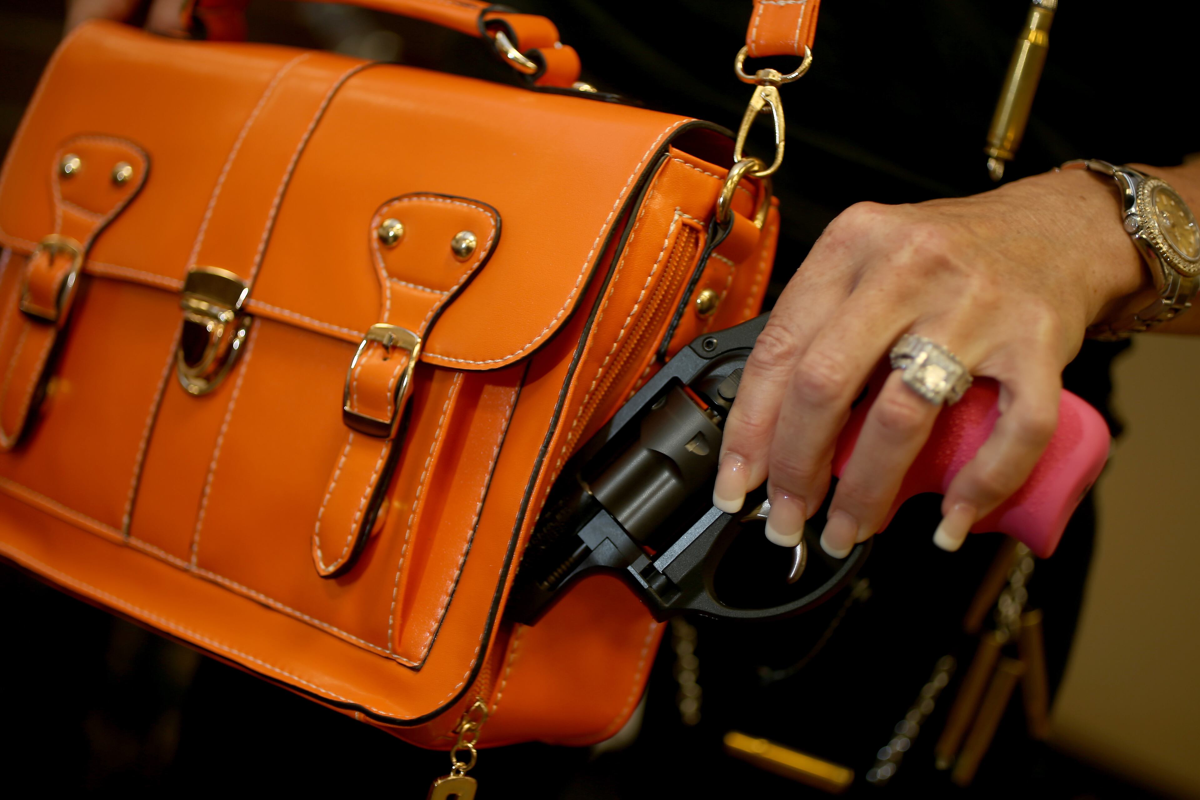 Susan Kushlin poses with a concealed-carry handbag from Gun Girls Inc.