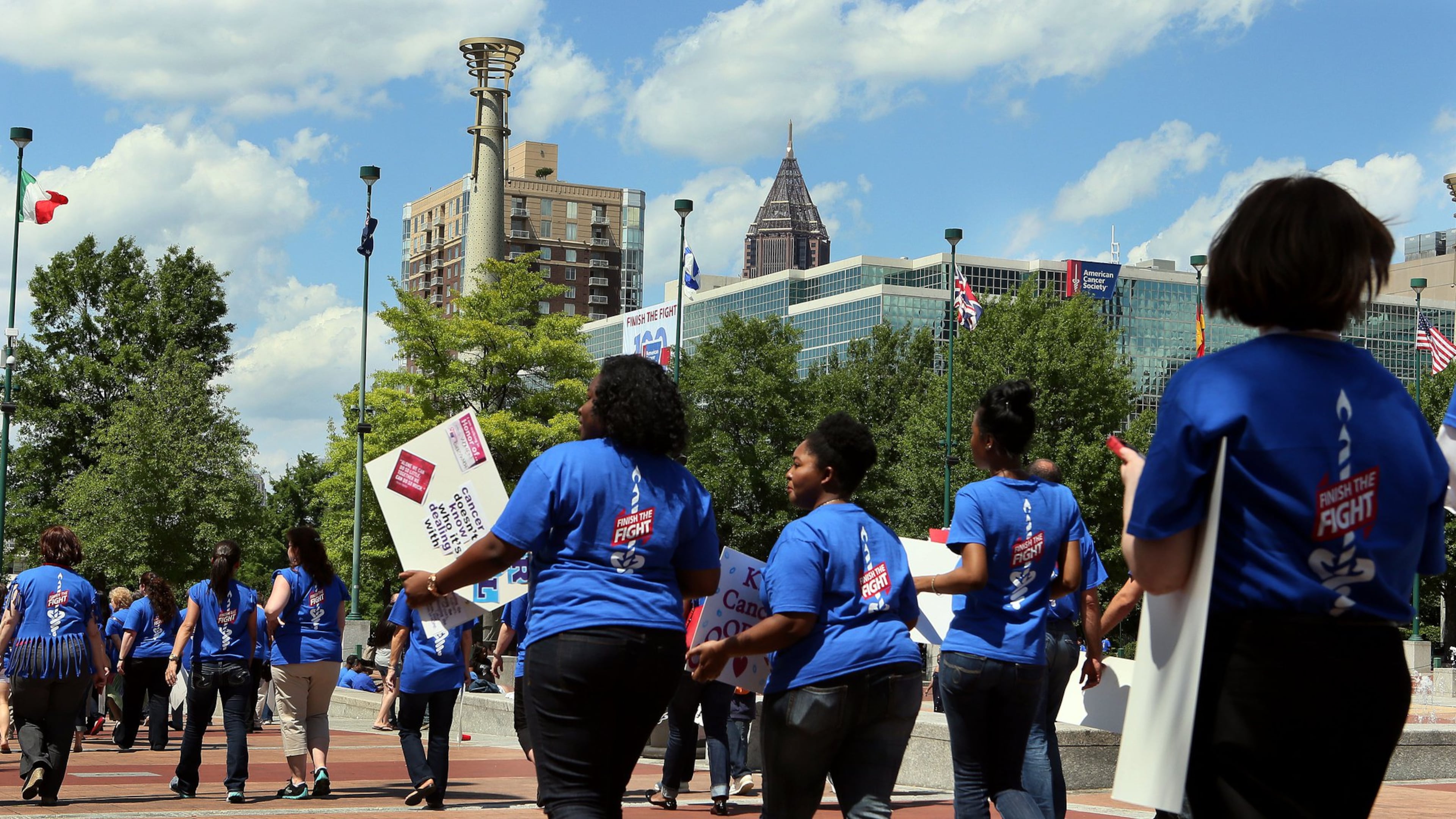 An estimated 450 American Cancer Society employees, volunteers and supporters march through Centennial Olympic Park in downtown Atlanta after a rally to celebrate the organization’s 100th birthday in 2013. The nonprofit announced layoffs June 10, 2020. File photo. (PHIL SKINNER/AJC)