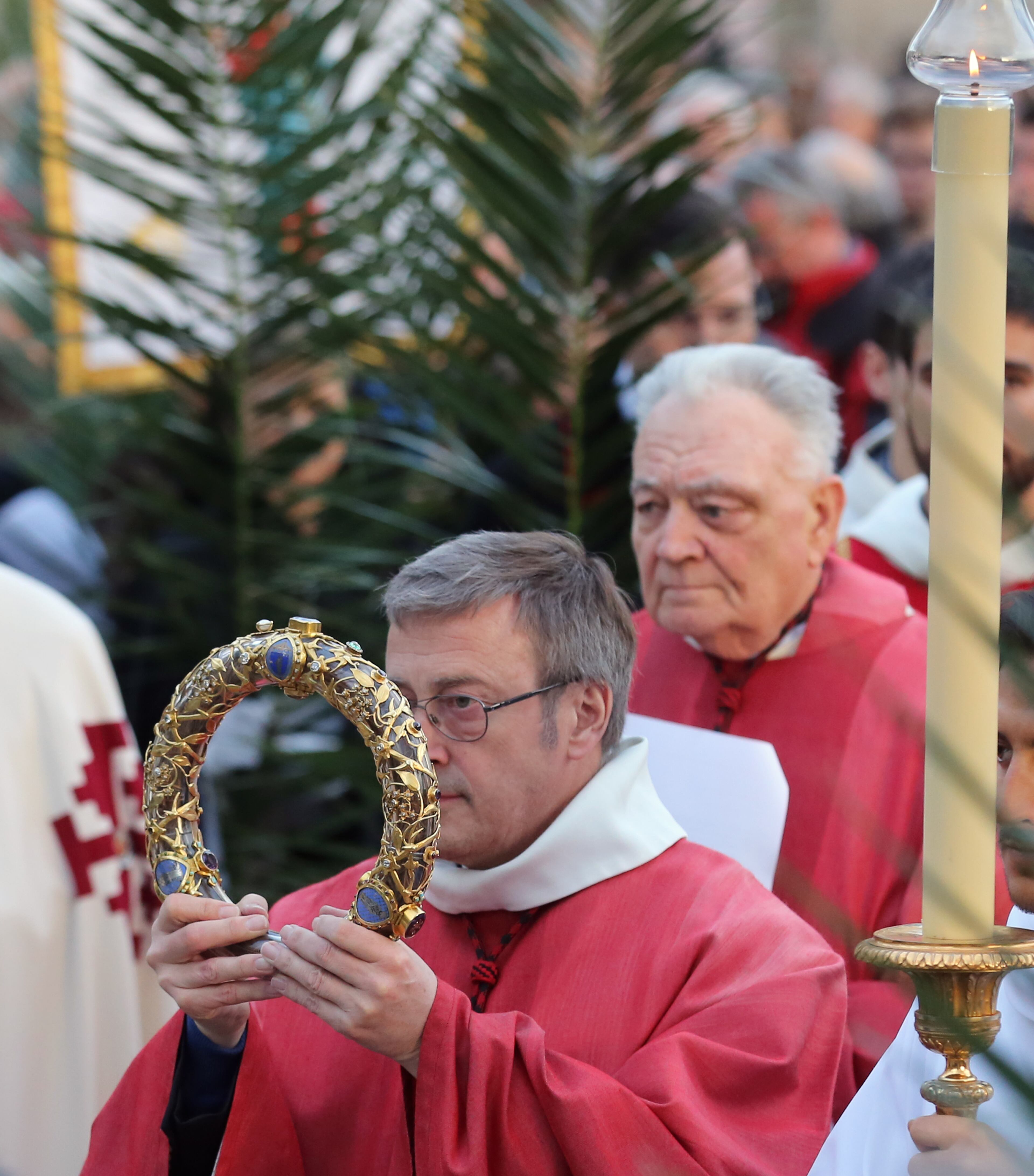 A crown of thorns which was believed to have been worn by Jesus Christ and which was bought by King Louis IX in 1239 is carried out of Notre Dame Cathedral in Paris, by Bishop Patrick Chauvet, Friday March 21, 2014. To mark the 800th anniversary of Louis IX's christening, the crown of thorns will be displayed outside Notre Dame, at the Collegiate Church of Poissy, where King Louis IX was christened. (AP Photo/Remy de la Mauviniere)