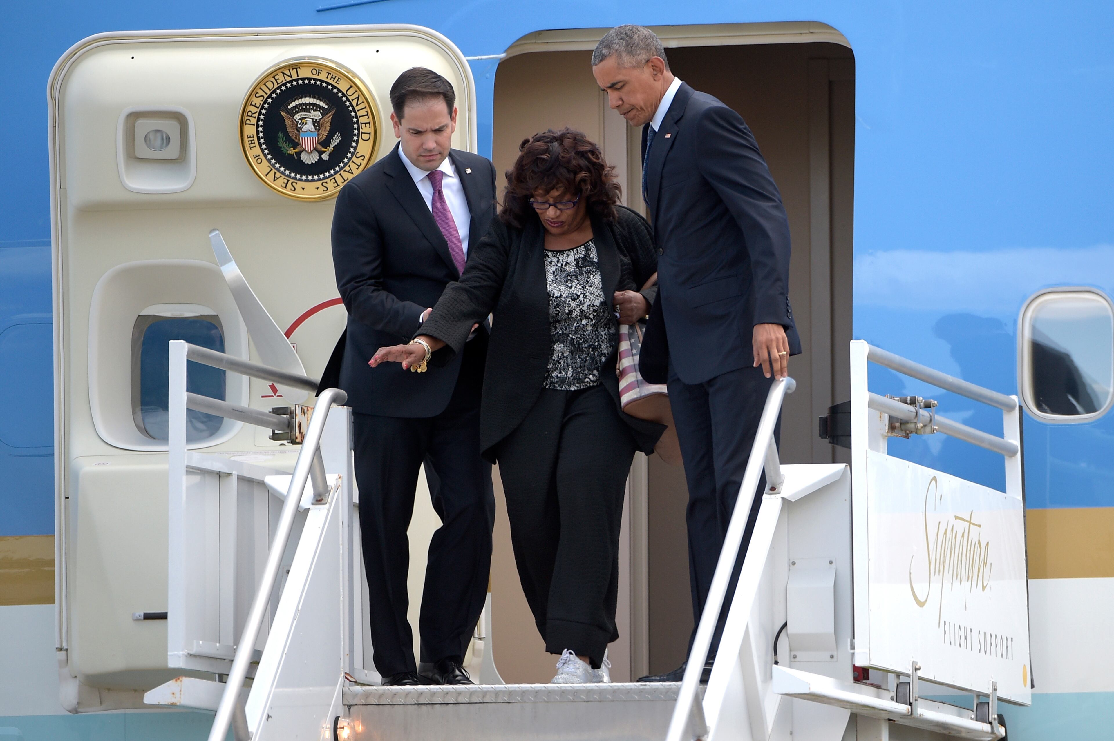 President Barack Obama, and Sen. Marco Rubio, R-Fla., left, help Rep. Corrine Brown, D-Fla., as they get off Air Force One at Orlando International Airport in Orlando, Fla., Thursday, June 16, 2016. Obama is in Orlando today to pay respects to the victims of the Pulse nightclub shooting and meet with families of victims of the attack. (AP Photo/Phelan M. Ebenhack)