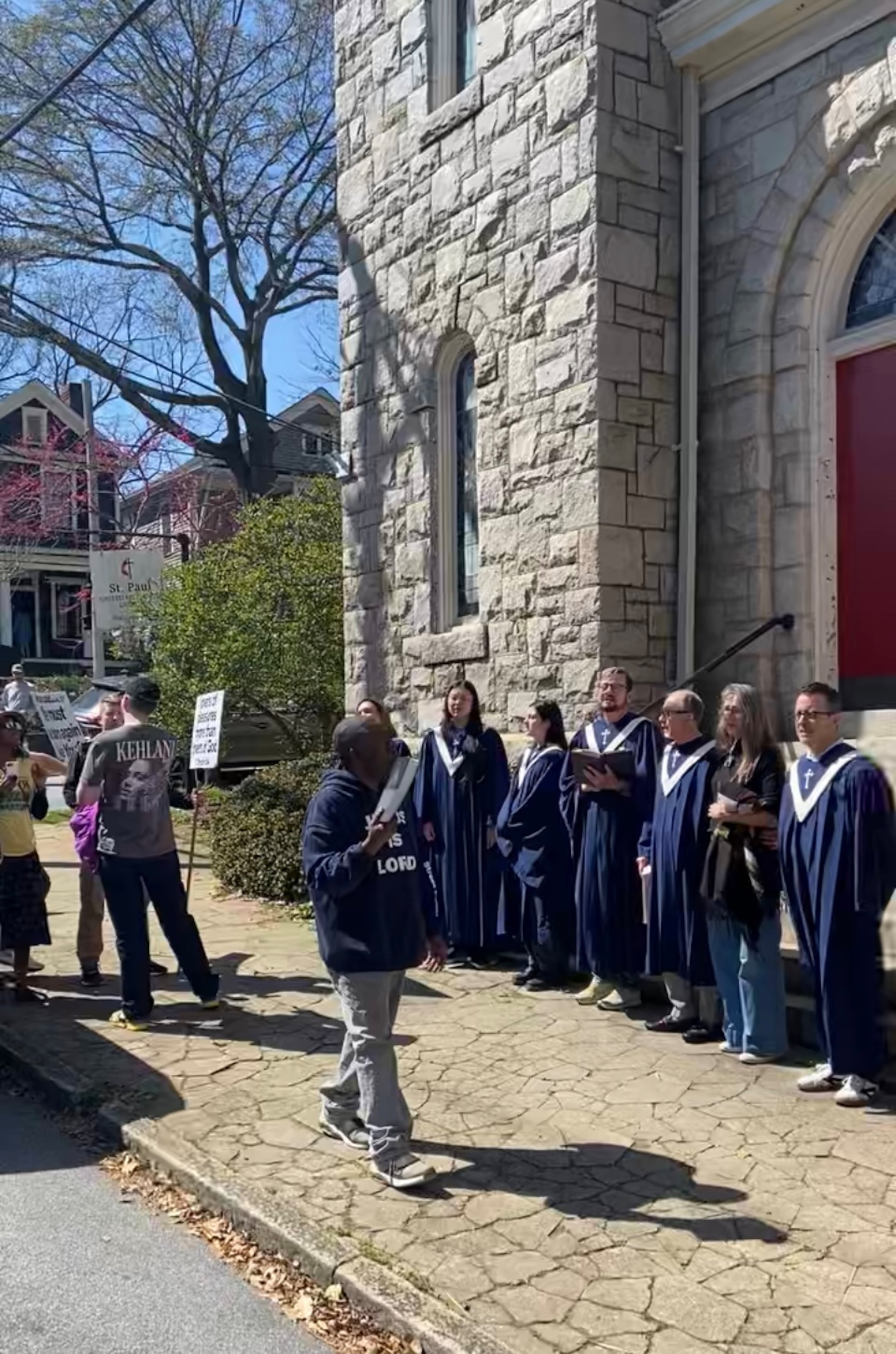 After enduring an hour of amplified protest outside their church, members of St. Paul United Methodist Church processed outside and sang to their tormentors.