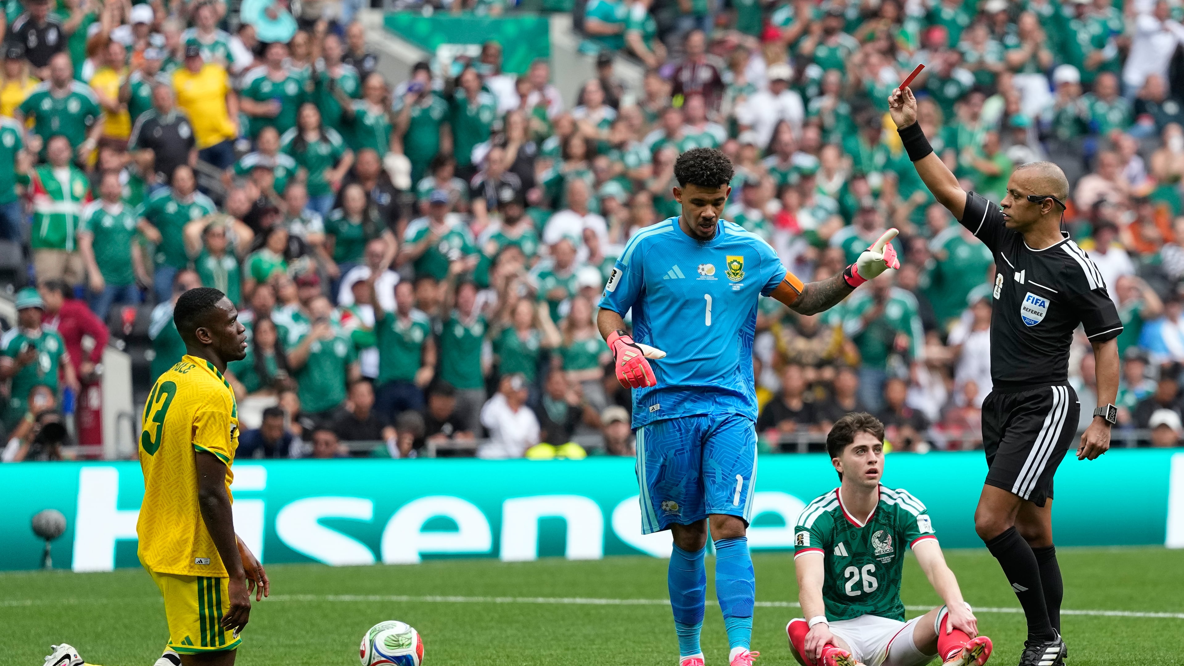 Referee Wilton Sampaio a red card to South Africa's Sphephelo Sithole, left, during the World Cup Group A soccer match between Mexico and South Africa in Mexico City, Thursday, June 11, 2026. (AP Photo/Natacha Pisarenko)