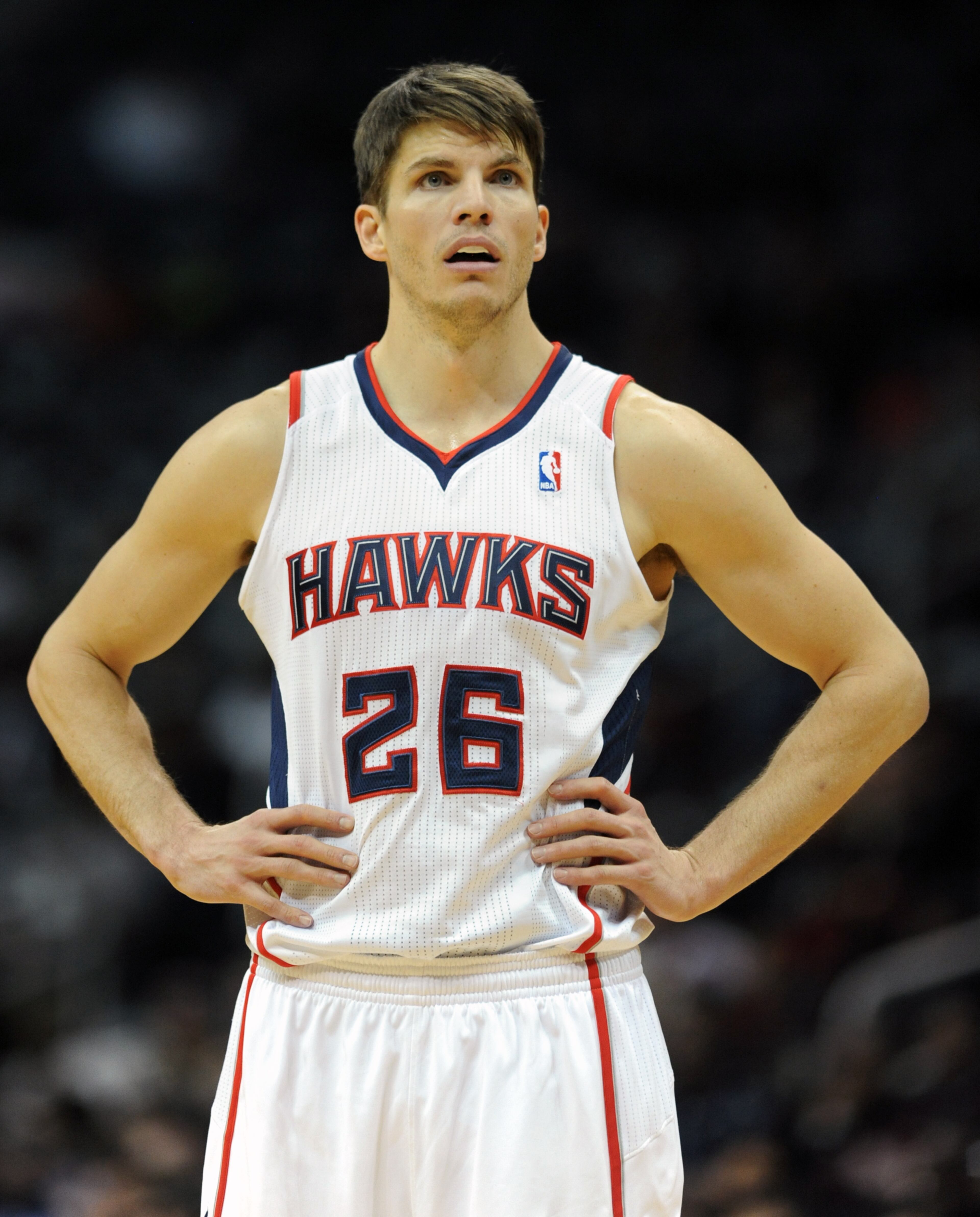 Kyle Korver watches as a Sacramento Kings player shoots free throws.