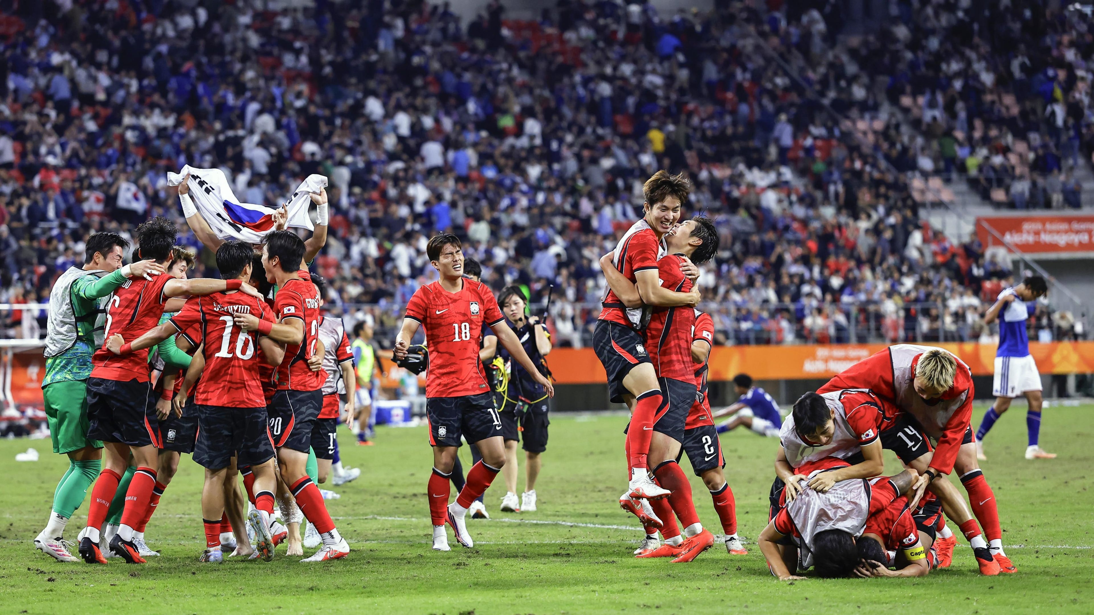 South Korea's team members celebrate as they defeated Japan in the men’s final in football at the Asian Games in Toyota, central Japan, Saturday, Oct. 3, 2026. (Atsuhiro Maeda/Kyodo News via AP)