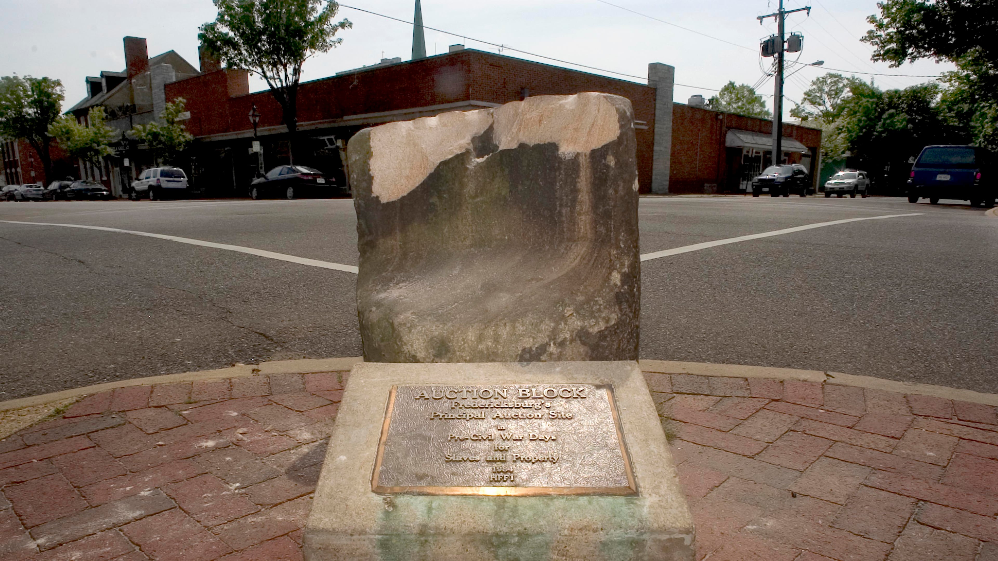 A pre-Civil War auction block, which weighs 800 pounds, was pulled from the ground at a Fredericksburg street corner early Friday.