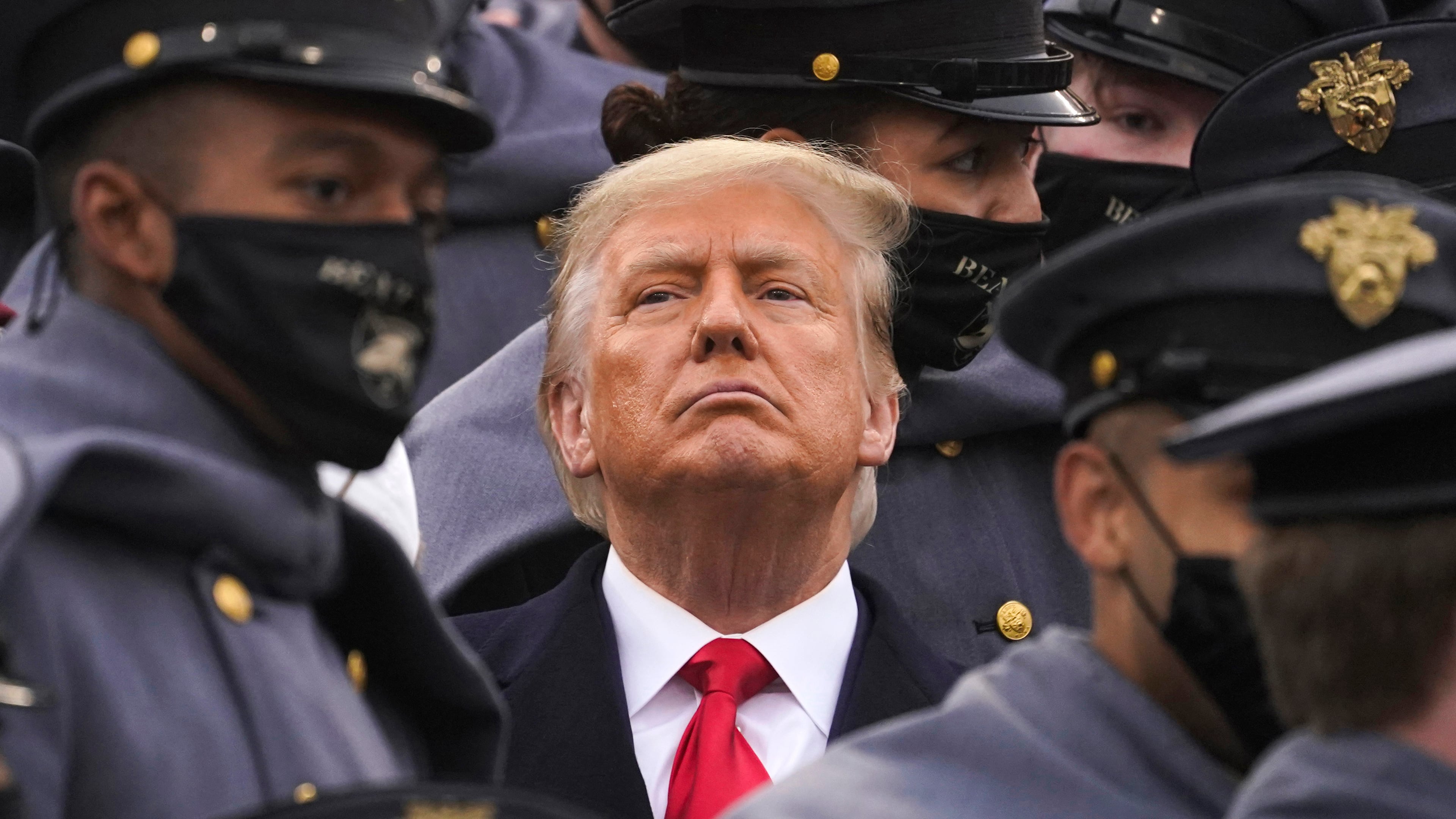 FILE - Surrounded by Army cadets, President Donald Trump watches the first half of the 121st Army-Navy Football Game, Dec. 12, 2020, in West Point, N.Y. (AP Photo/Andrew Harnik, File)