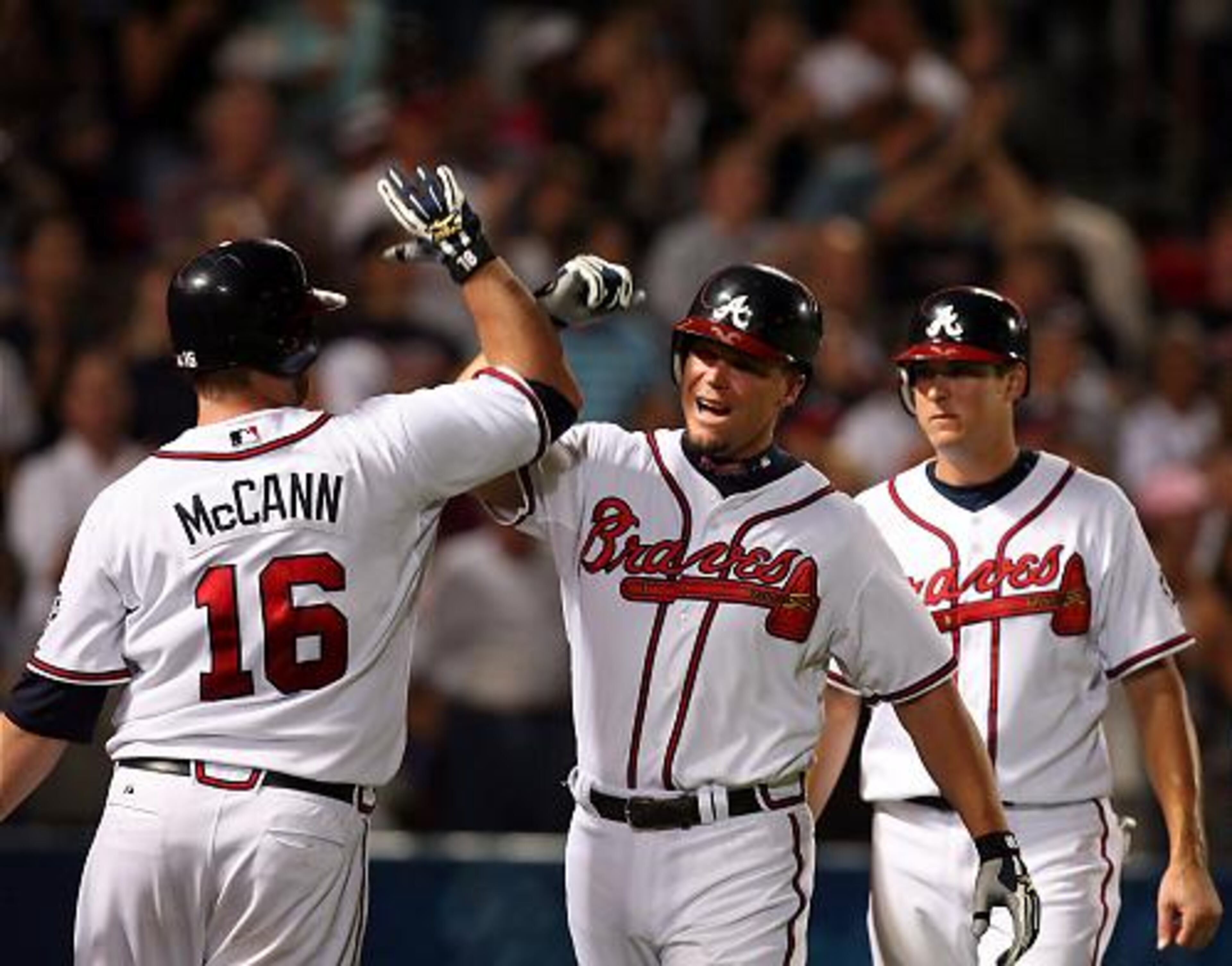 Catcher Brian McCann congratulates Chipper Jones on his home run in the third inning that gave the Braves a three-run lead against the Nationals.