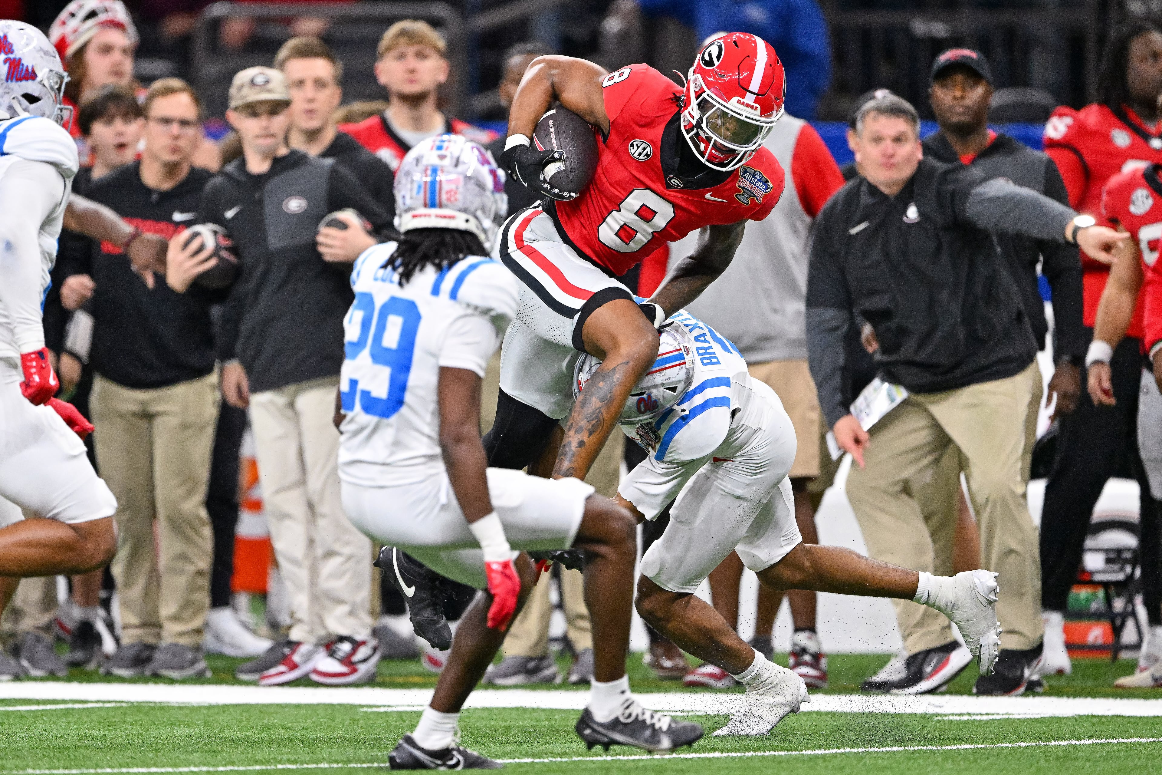 Georgia Bulldogs wide receiver Colbie Young (8) leaps over Ole Miss Rebels safety Nick Cull (29) during the fourth quarter of the NCAA College Football Playoff quarterfinal game at the Sugar Bowl in the Caesars Superdome, Thursday, Jan. 1, 2026, in New Orleans. (Hyosub Shin/AJC)