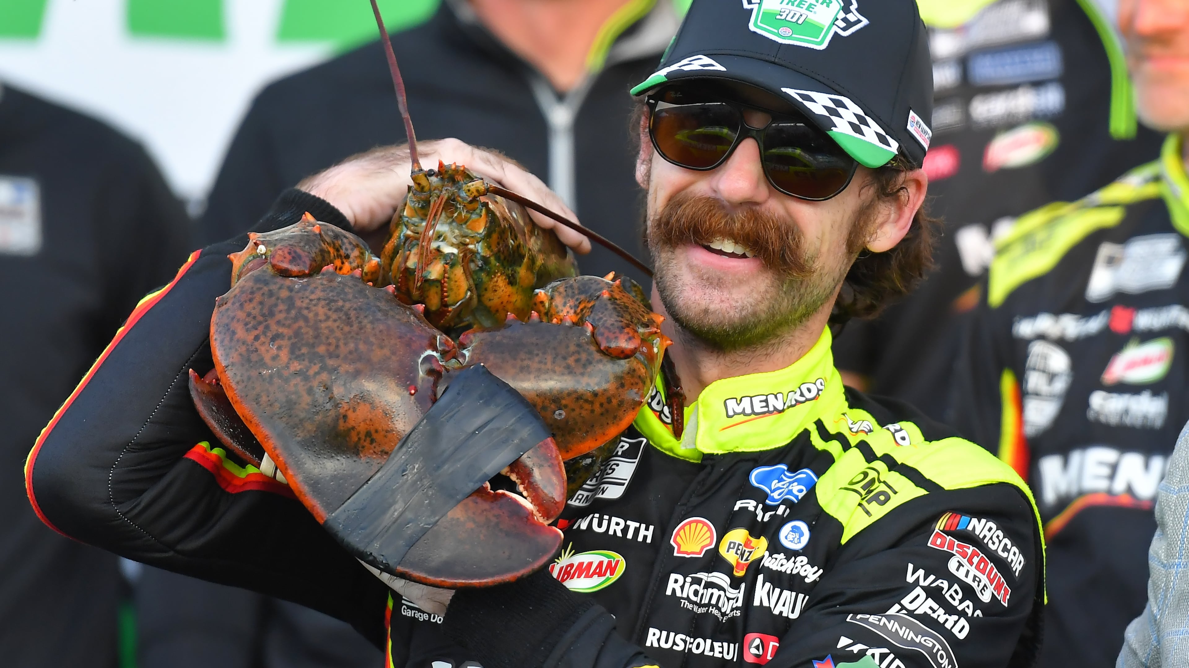 Ryan Blaney displays a lobster, a Victory Lane tradition at New Hampshire Motor Speedway, after winning a NASCAR Cup Series auto race, Sunday, Aug. 23, 2026, at the speedway in Loudon, N.H. (AP Photo/Steven Senne)