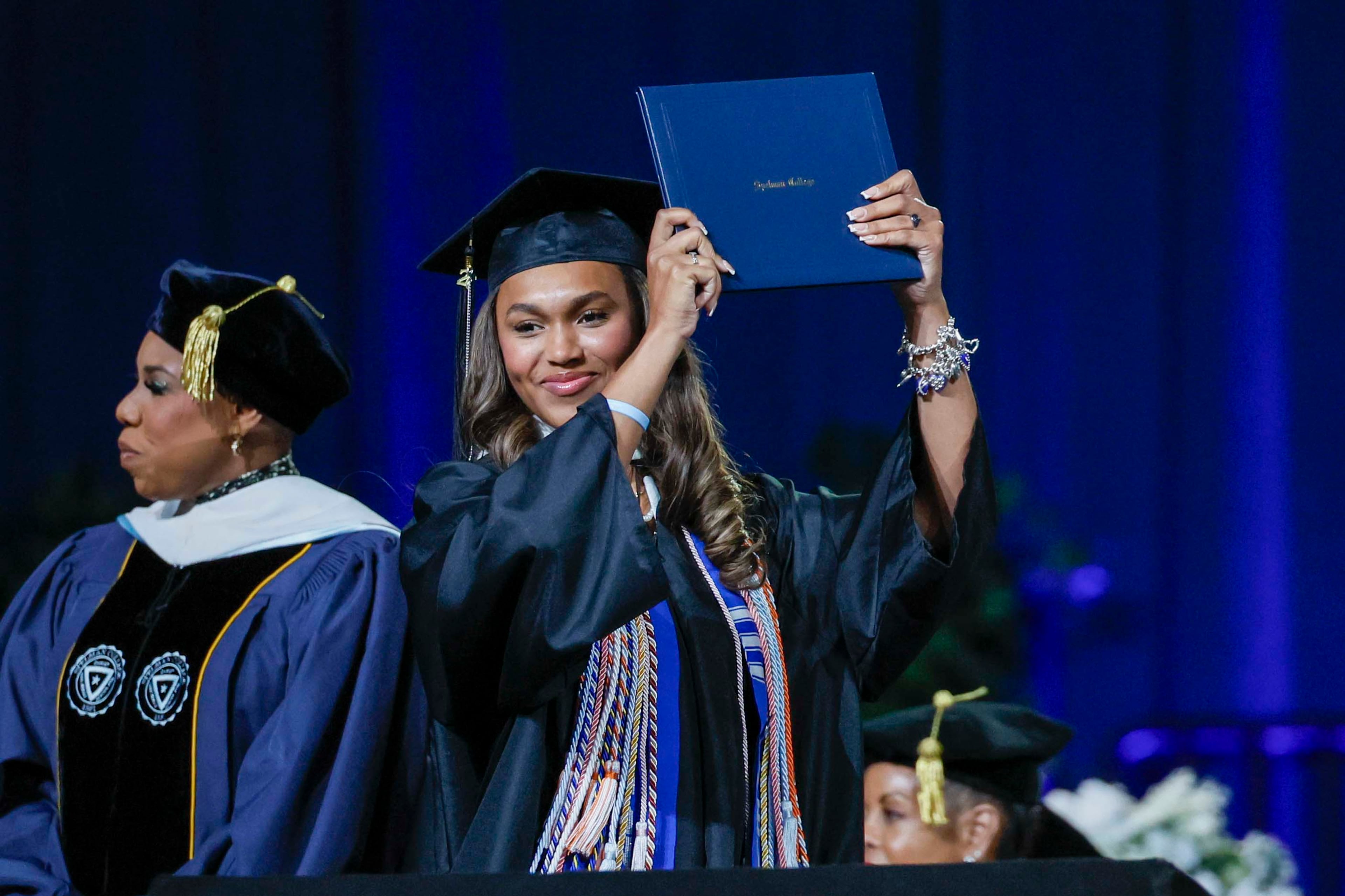 A graduate reacts after receiving her diploma during the Spelman College Commencement at the Georgia International Convention Center in College Park on Sunday, May 17, 2026. (Miguel Martinez/AJC)