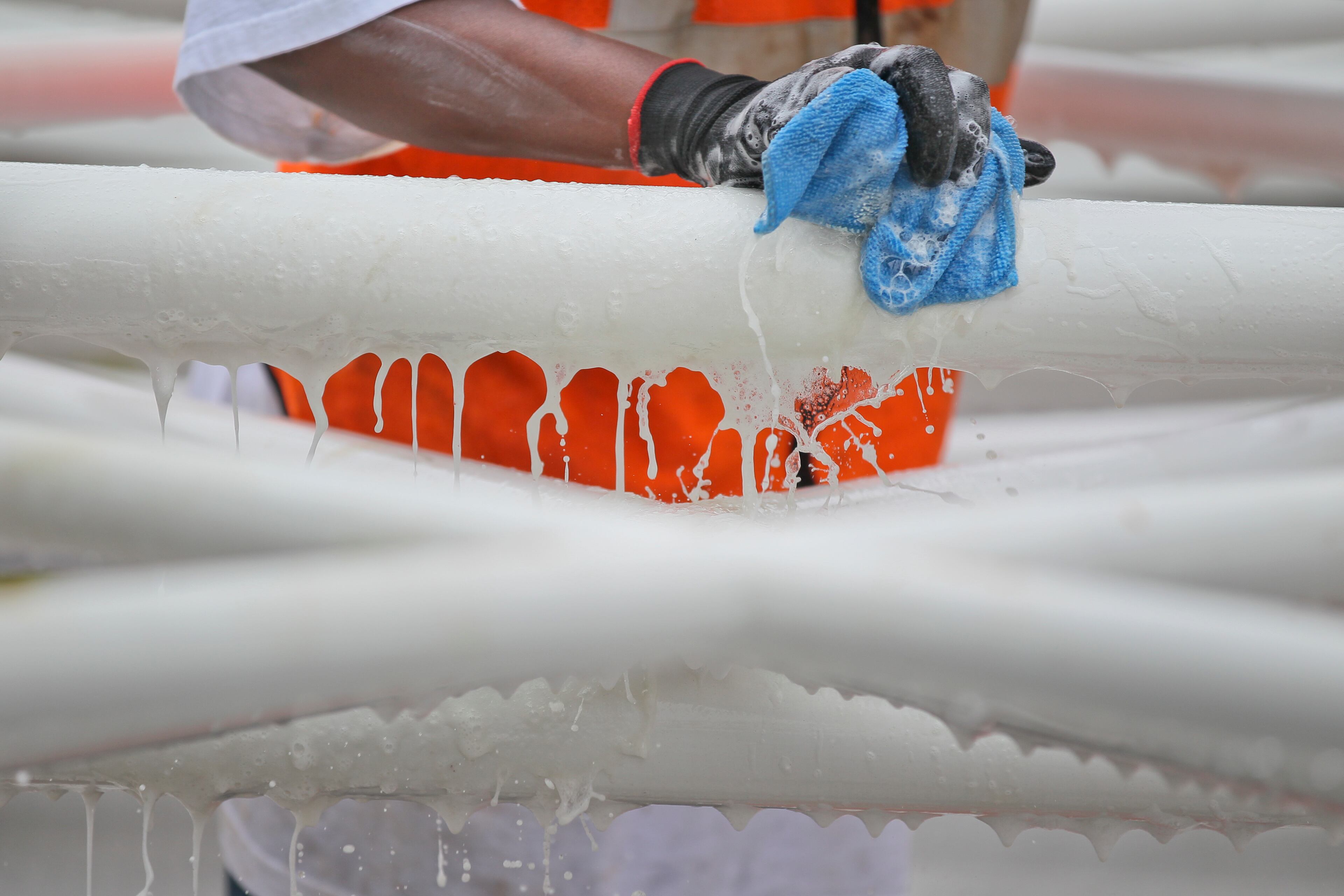Justin Jackson with SkyView Atlanta cleans the structure before assembly. The 200 foot observation wheel was taking shape Tuesday, July 9, 2013 across the street from Centennial Olympic Park next to the Tabernacle where SkyView, General Manager, Michael Montgomery says the assembly of the SkyView Ferris wheel and its 42-climate controlled gondolas should be up and operational by the weekend or first of next week. By the time it is said and done - 30-tractor trailer full of materials will have been delivered for the project. The Ferris wheel is designed and constructed by Ronald Bussink from Munich, Germany. There are 1200 pins and clips to inspect during a three hour safety and maintenance inspection before opening every day. The V.I.P. gondola has a leather interior, a glass bottom and glass chillers on the console. A flight, or four revolutions takes about 15-minutes. Up to 6-adults may fit in a gondola. Tickets to fly are $13.50 for adults and $ 8.50 for children. JOHN SPINK/JSPINK@AJC.COM