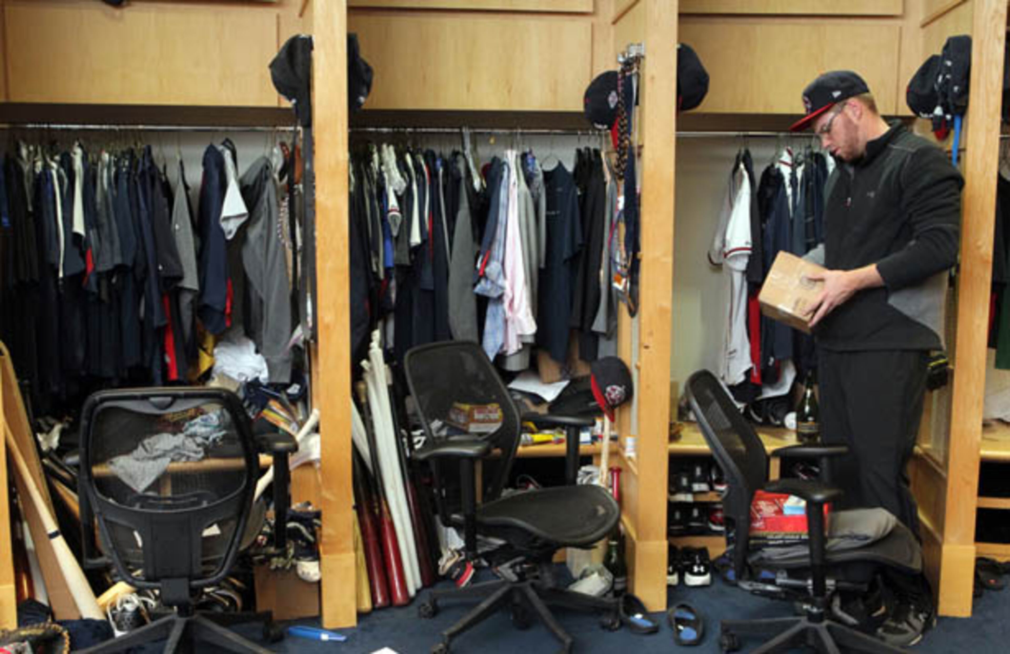 Braves first baseman Freddie Freeman looks through a box as he empties out the belongings from his locker at Turner Field Saturday.