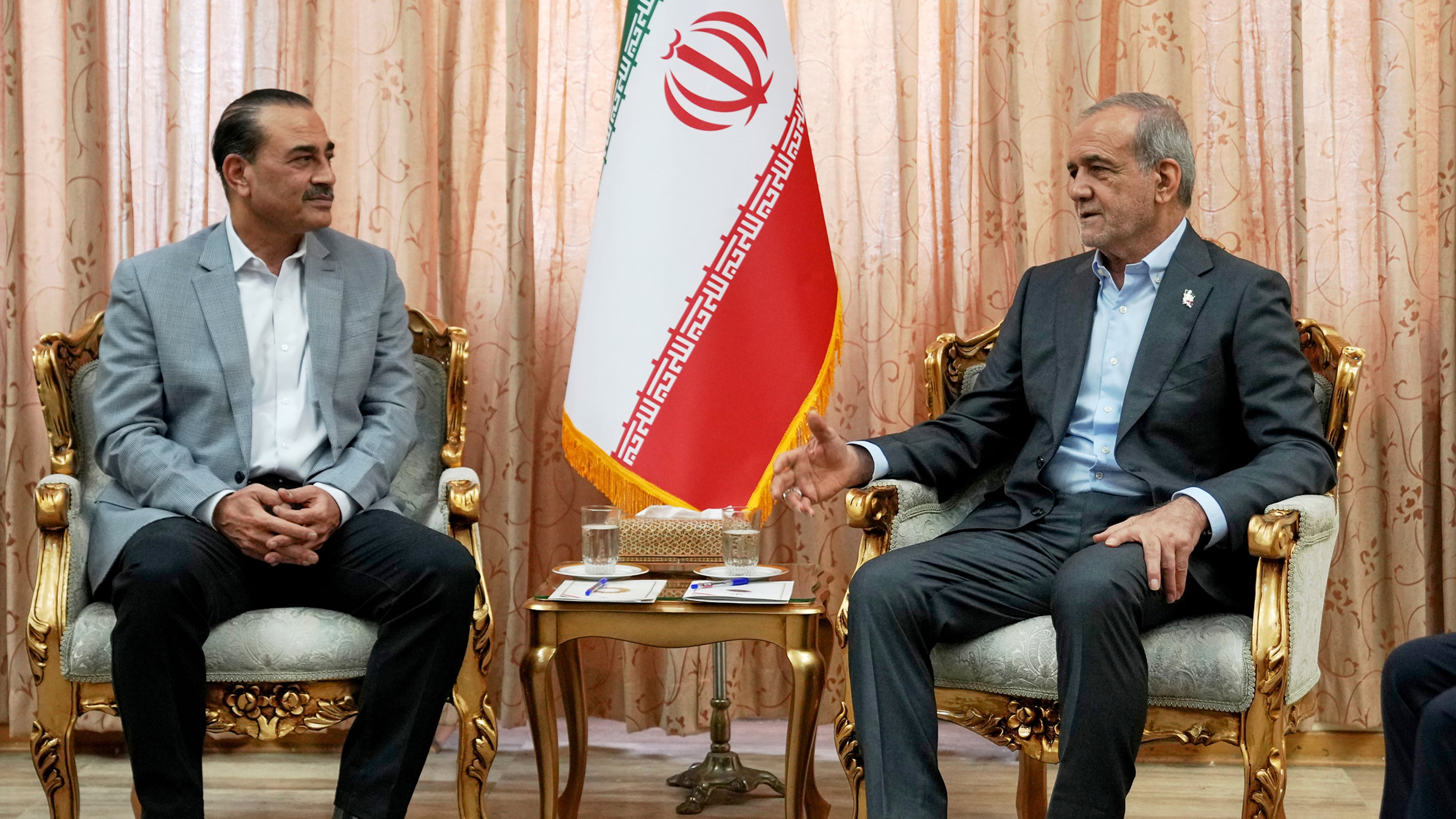 In this photo released by the Iranian Presidency Office, President Masoud Pezeshkian, right, speaks with Pakistan's Army Chief Field Marshal Gen. Asim Munir in Tehran, Iran, Saturday, May 23, 2026. (Iranian Presidency Office via AP)