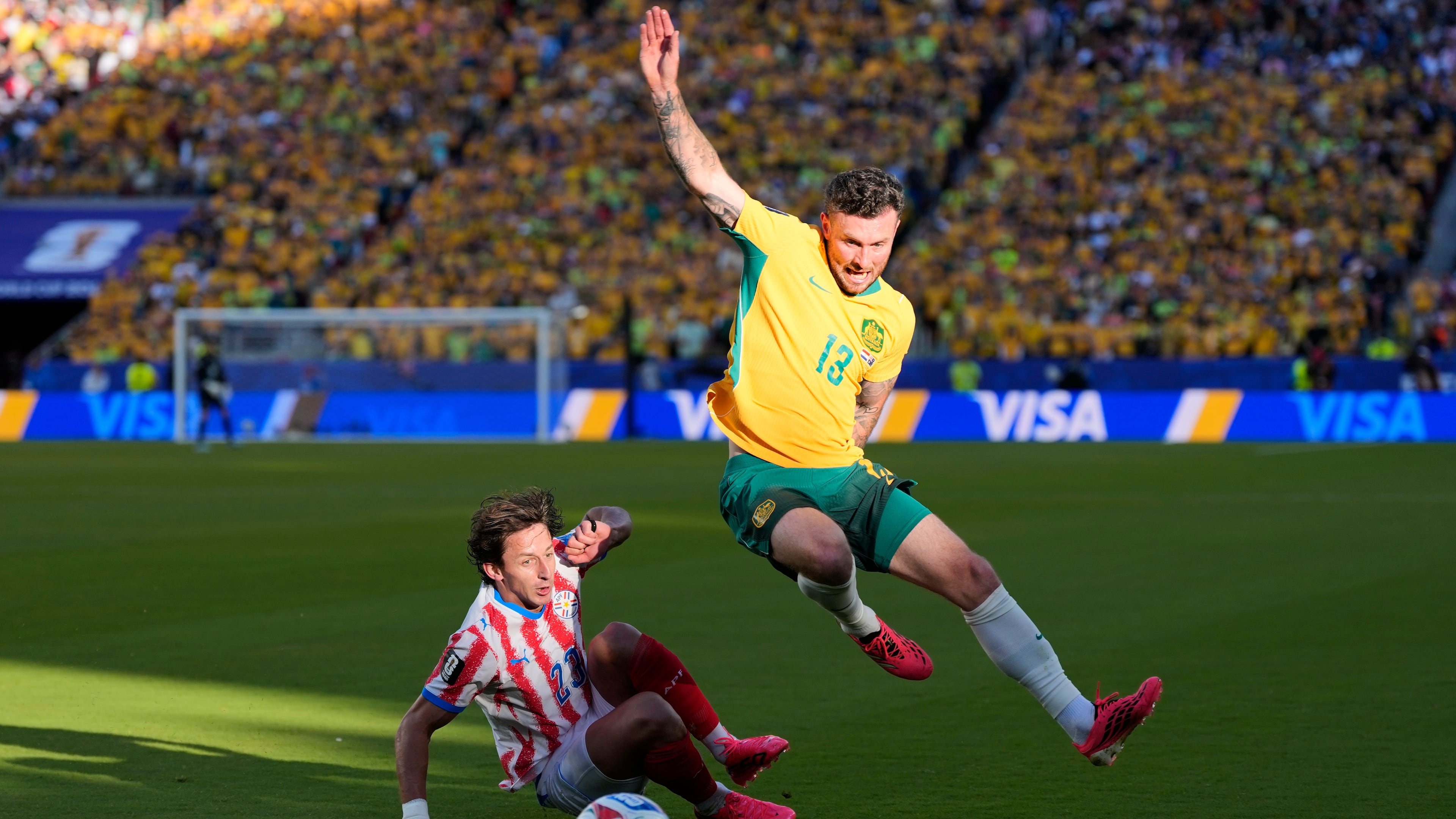 Australia's Aiden O'Neill (13) battles for the ball with Paraguay's Matias Galarza (23) during the World Cup Group D soccer match between Paraguay and Australia in Santa Clara, Calif., near San Francisco, Thursday, June 25, 2026. (AP Photo/Eugene Hoshiko)