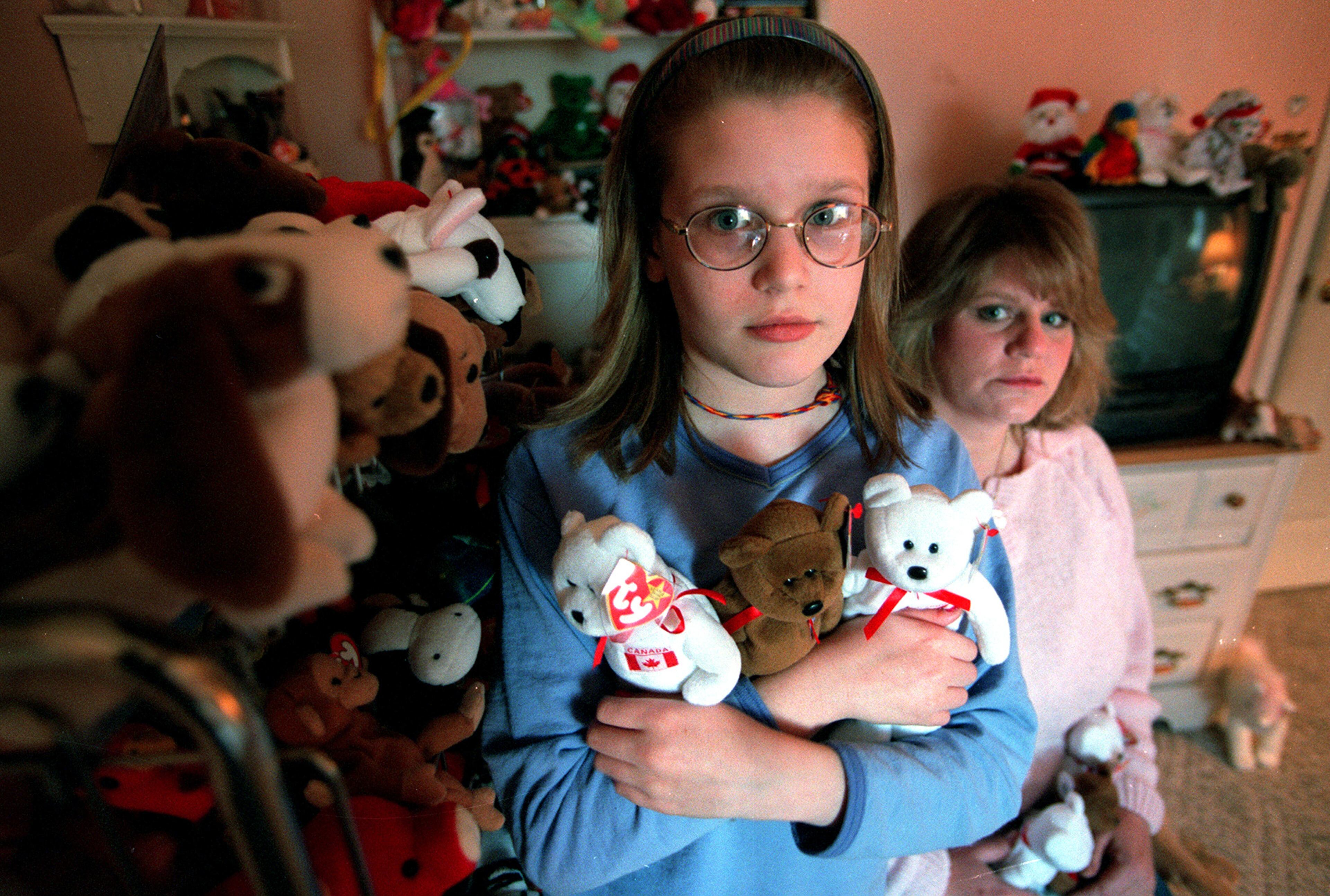 990322 CHEROKEE -- Ten-year-old Shannon Gross (cq) holds three of the nine fake Beanie Babies her mom, Gail Gross (CQ), bought for her as a Christmas present last year. Under the assumption that the Beanie Babies were authentic, Mrs. Gross spent $1500 on the dolls thinking she was getting a great deal, finding out later that she had been scammed. (ALICIA HANSEN/STAFF)