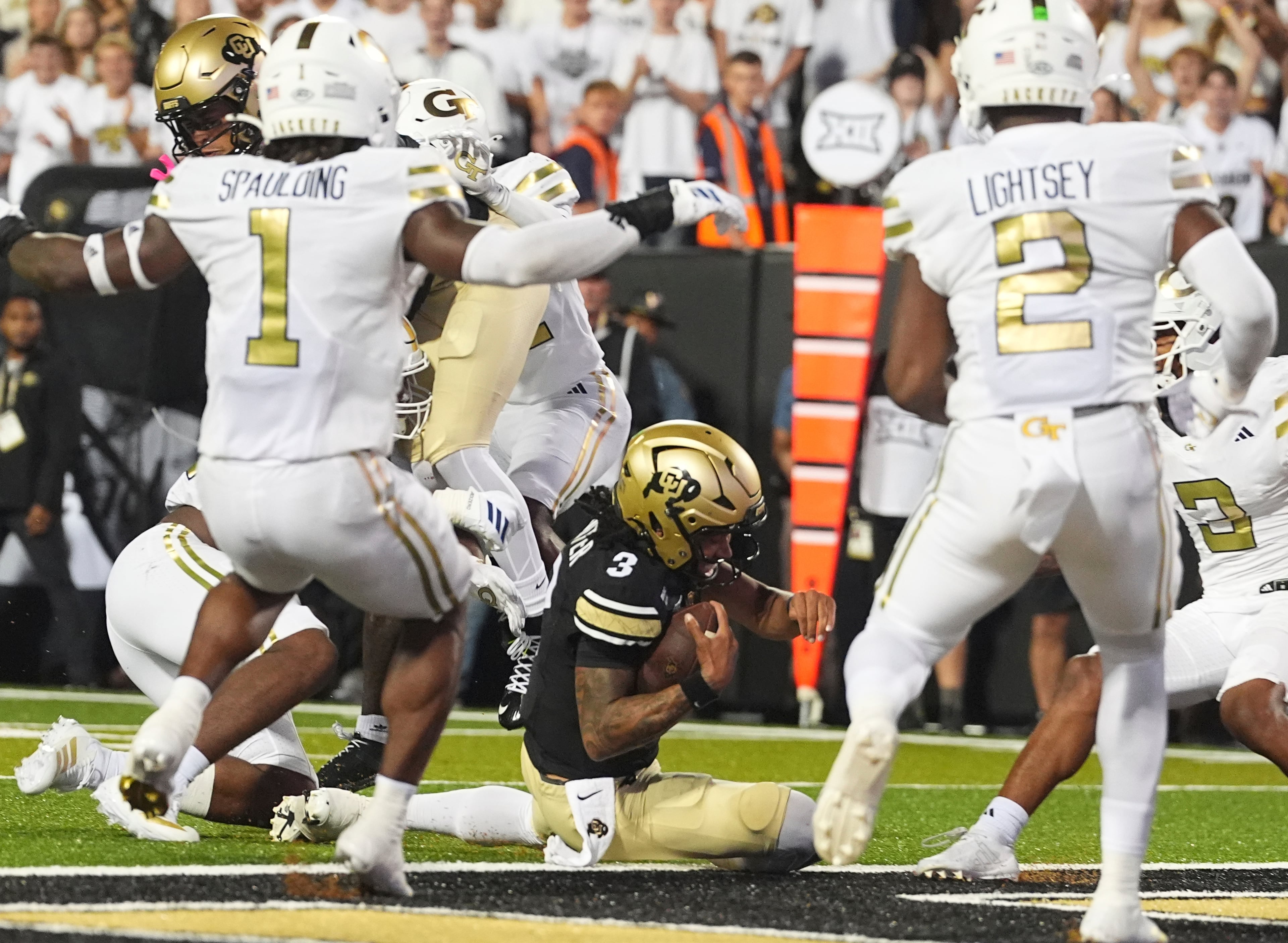 Colorado quarterback Kaidon Salter (center) slides into the end zone for a touchdown between Georgia Tech linebackers Cayman Spaulding (left) and E.J. Lightsey during the second half on Friday, Aug. 29, 2025, in Boulder, Colo. (David Zalubowski/AP)