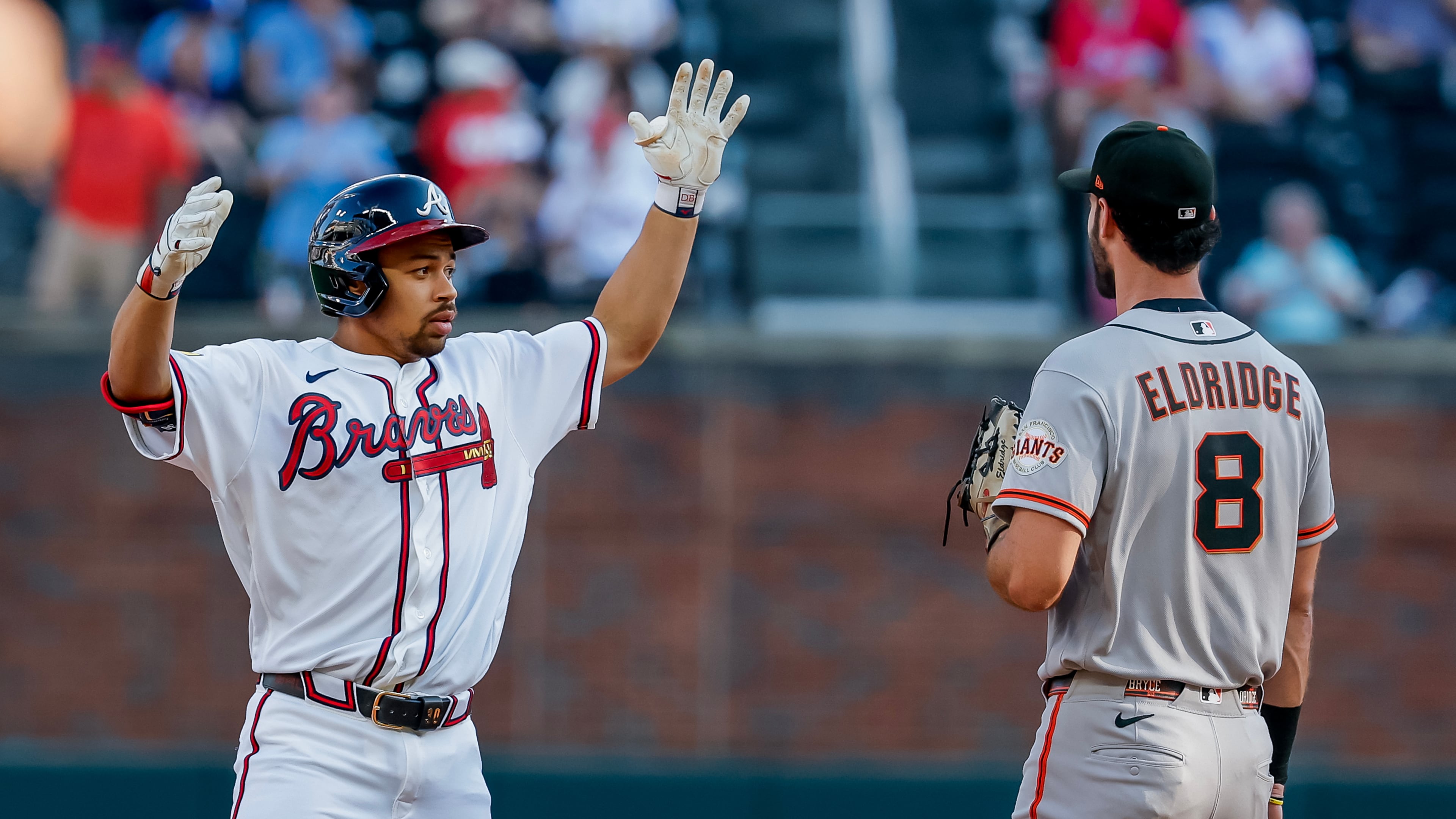 Braves designated hitter Drake Baldwin (left) celebrates after hitting a double as San Francisco Giants first baseman Bryce Eldridge stands by on Monday, Aug. 31, 2026, in Atlanta. The numbers overwhelmingly favor the Braves to make the playoffs. (Erik S. Lesser/AP)