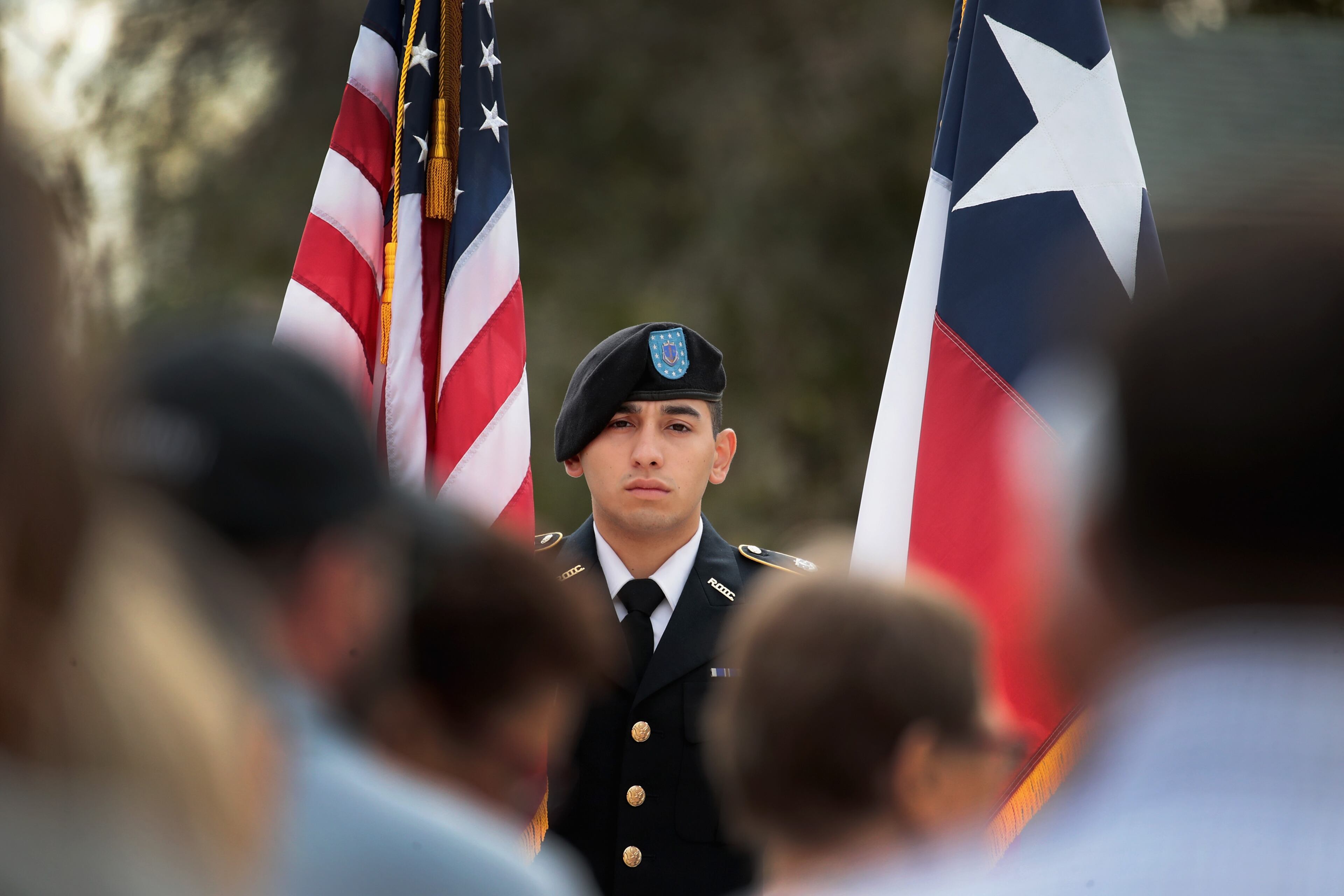 SUTHERLAND SPRINGS, TX - NOVEMBER 11: Joshua Tinajero holds colors during a Veterans Day ceremony outside the town's Community Center on November 11, 2017 in Sutherland Springs, Texas. Residents of the community are still trying to heal following the shooting at the First Baptist Church of Sutherland Springs on November 5. Devin Patrick Kelley shot and killed 26 people and wounded 20 others when he opened fire during Sunday service at the church. (Photo by Scott Olson/Getty Images)