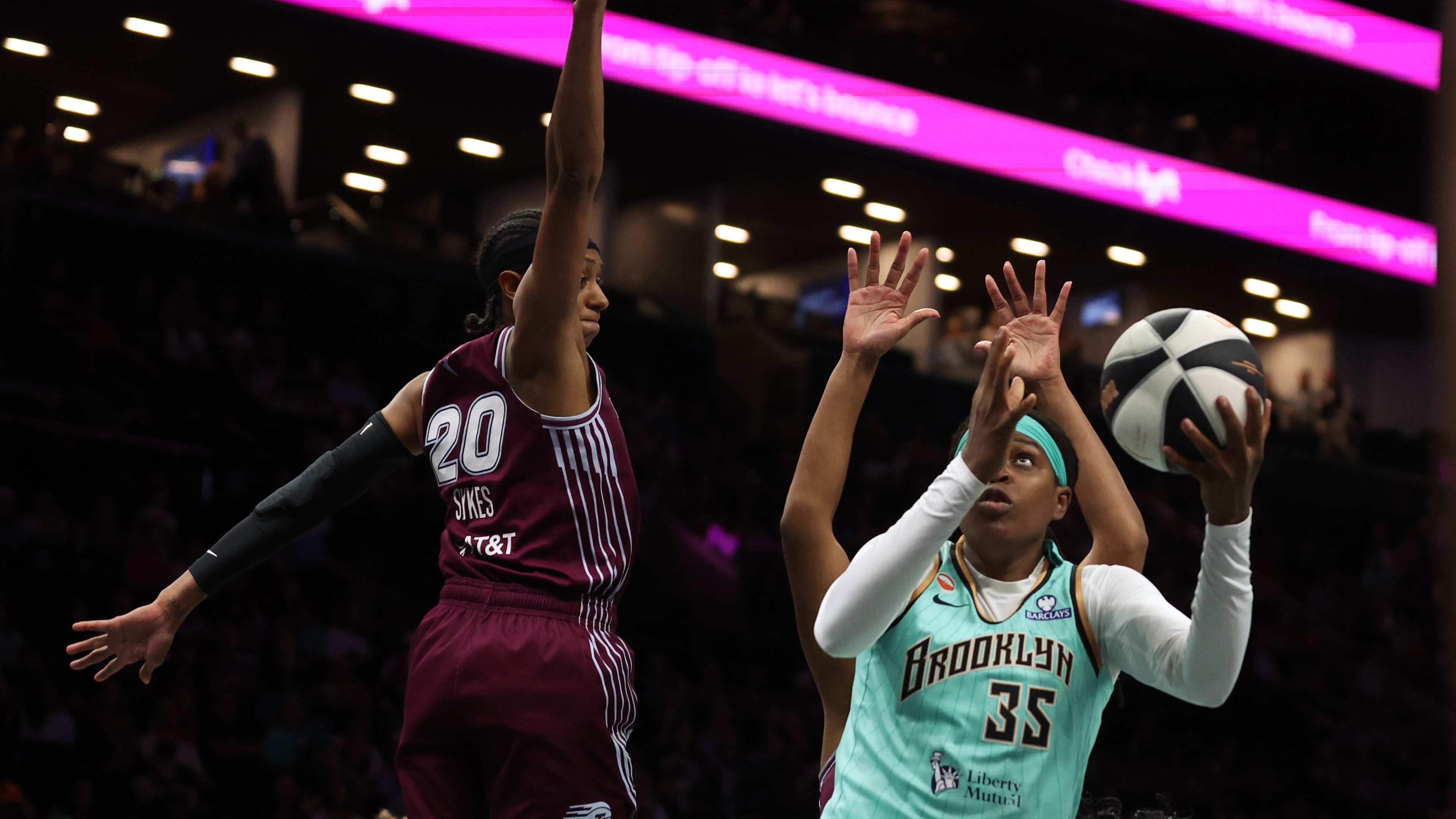 New York Liberty center Jonquel Jones (35) goes up for a shot against Toronto Tempo guard Brittney Sykes (20) during the first half of a WNBA basketball game, Wednesday, June 3, 2026, in New York. (AP Photo/Heather Khalifa)