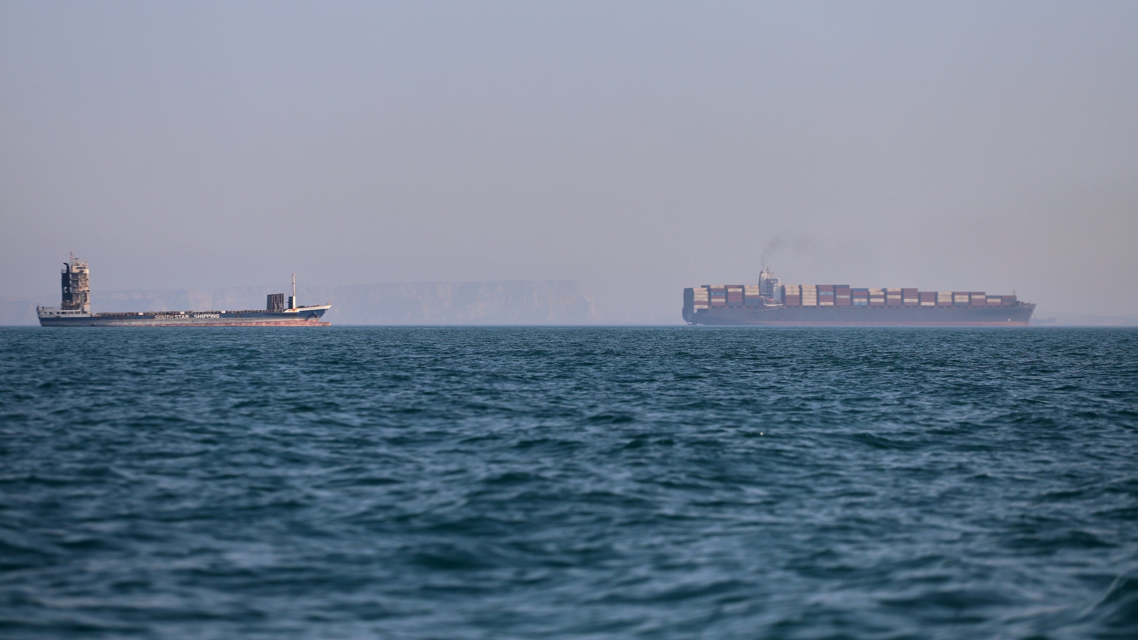A container ship, right, and a cargo vessel are seen in the Strait of Hormuz off Bandar Abbas, Iran, Wednesday, June 17, 2026. (Amirhosein Khorgooi/ISNA via AP)