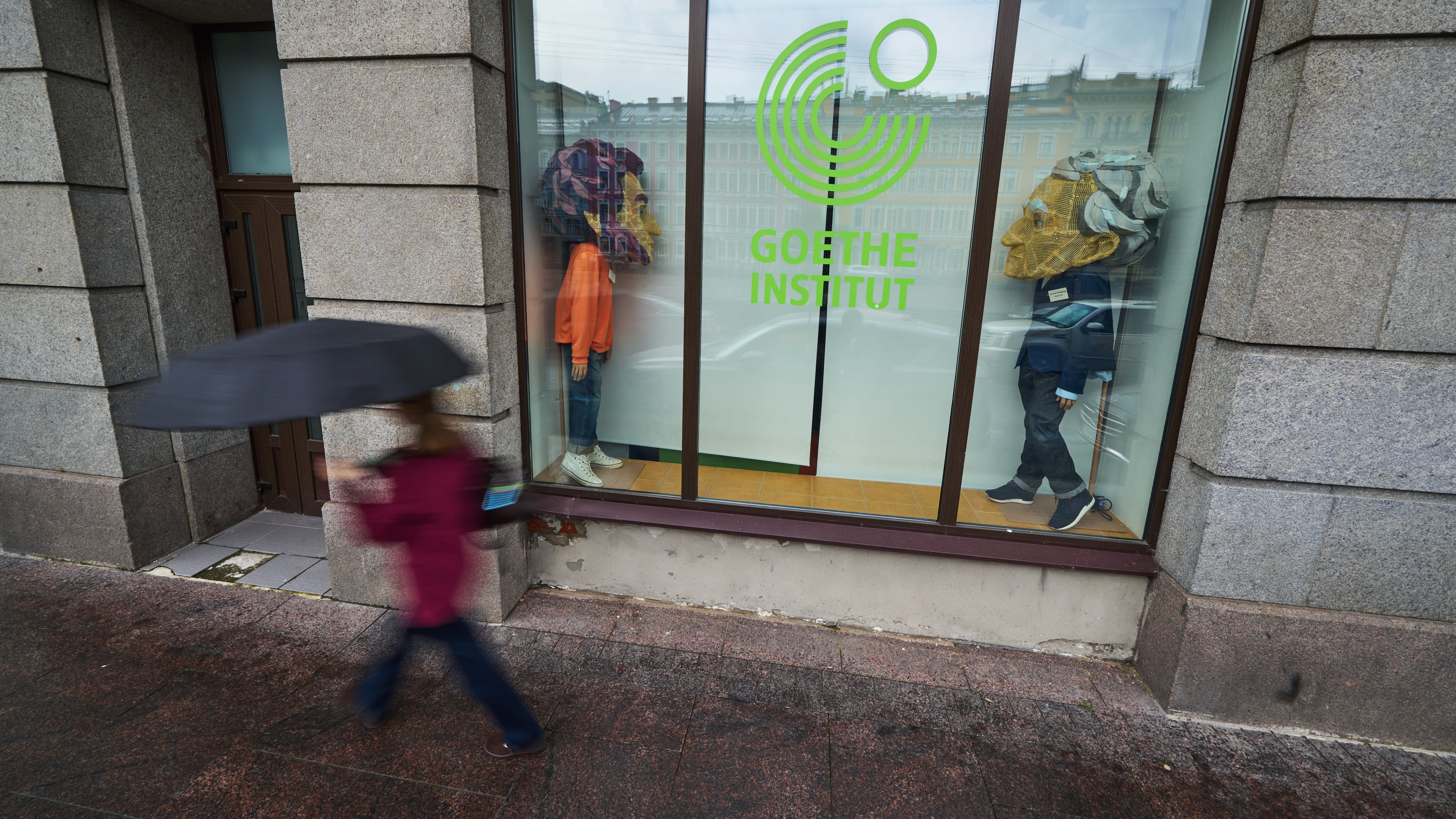 A person walks past figures depicting Johann Wolfgang Goethe, right, and Russian poet Alexander Pushkin installed in the window of the Goethe-Institut, Germany's cultural center in St. Petersburg, Russia, Thursday, Sept. 3, 2026. (AP Photo/Dmitri Lovetsky)