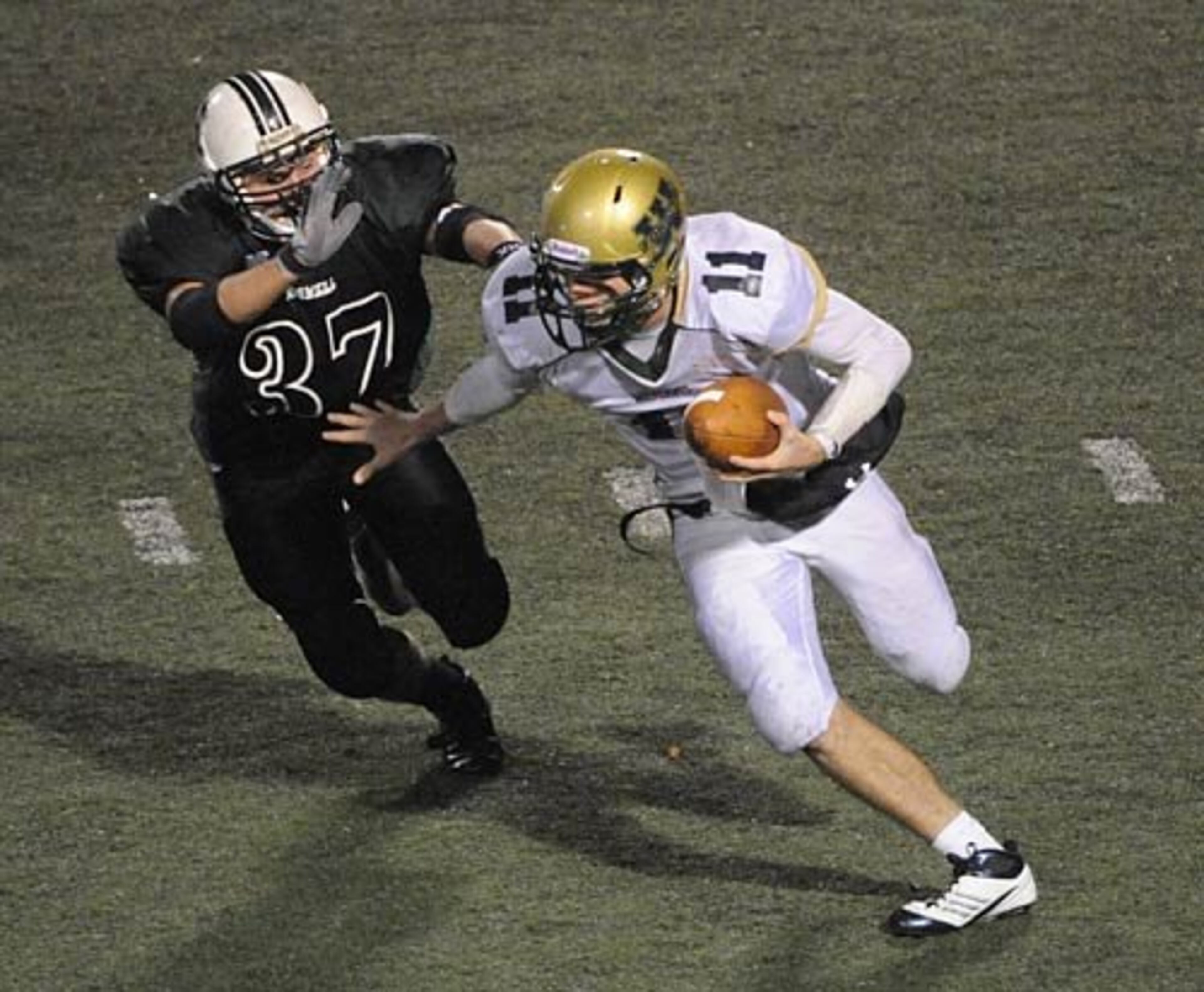 West Forsyth quarterback A.J. Erdely (11) staves off the tackle of Roswell linebacker Chris Yeager (37) during the fourth quarter.
