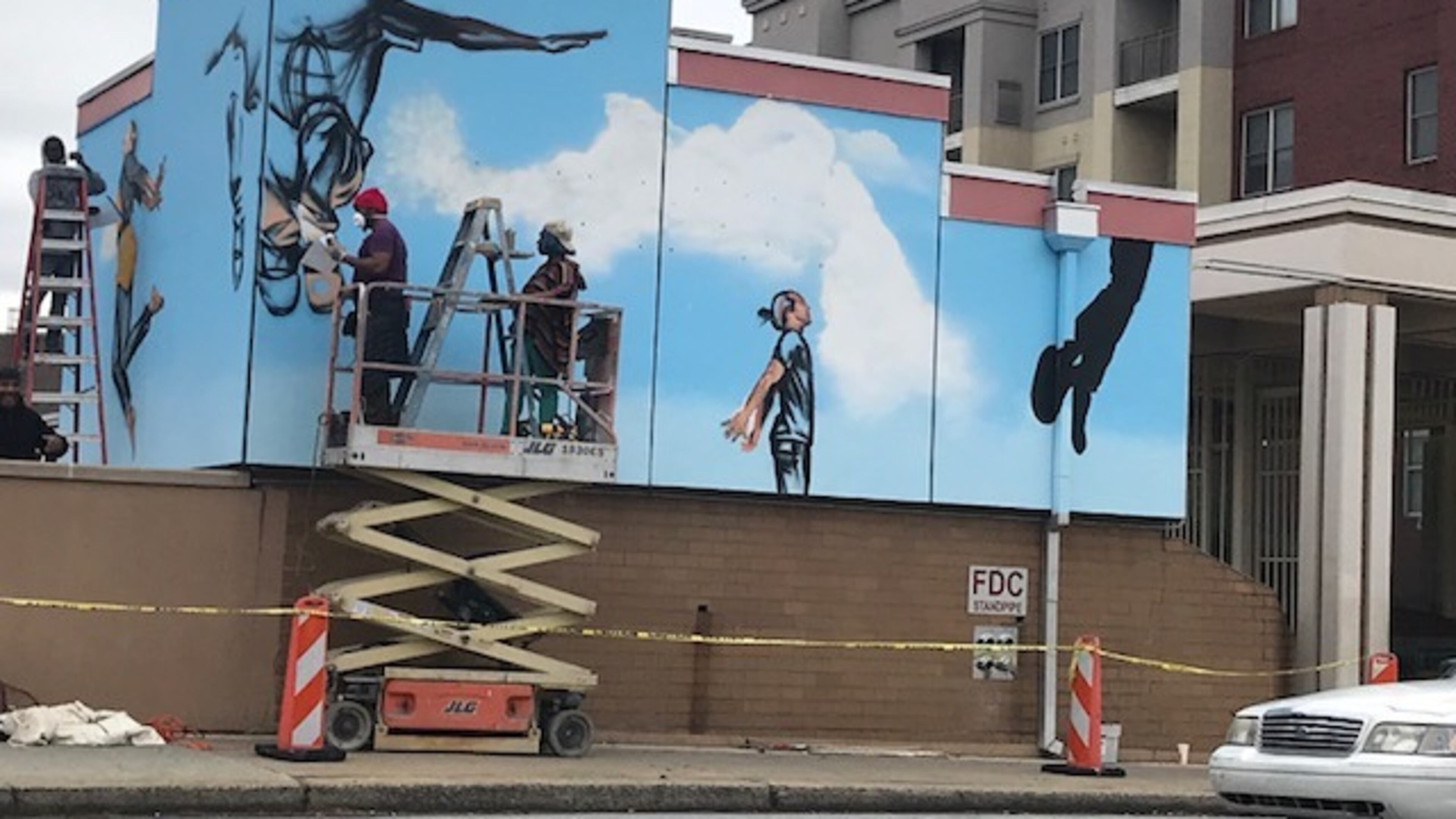 Fahamu Pecou with support artists Denisha Claxton and Fabian Williams worked on a mural called "The People Could Fly" at the Ashby Street MARTA station as part of the Transformation Alliance, coordinated by WonderRoot. CONTRIBUTED BY JOY BARNES