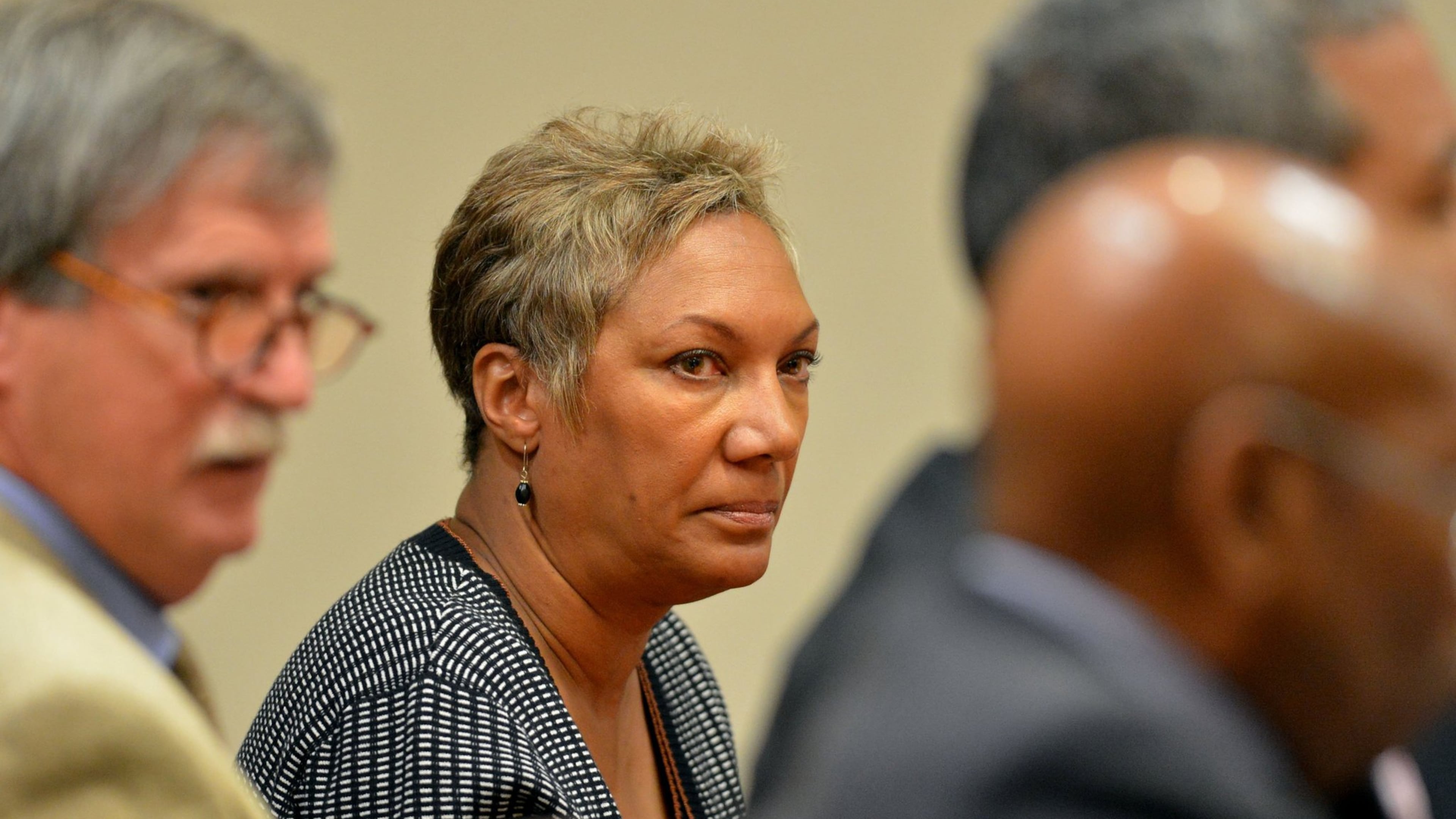 Pat Reid, co-defendant with former Dekalb County School Superintendent Crawford Lewis looks towards Lewis just before he plead guilty to obstruction of a law enforcement officer, a misdemeanor, in Dekalb County Superior Court before Judge Cynthia Becker Wednesday, October 16, 2013. Lewis was in court with co-defendants, Pat Reid and Tony Pope.