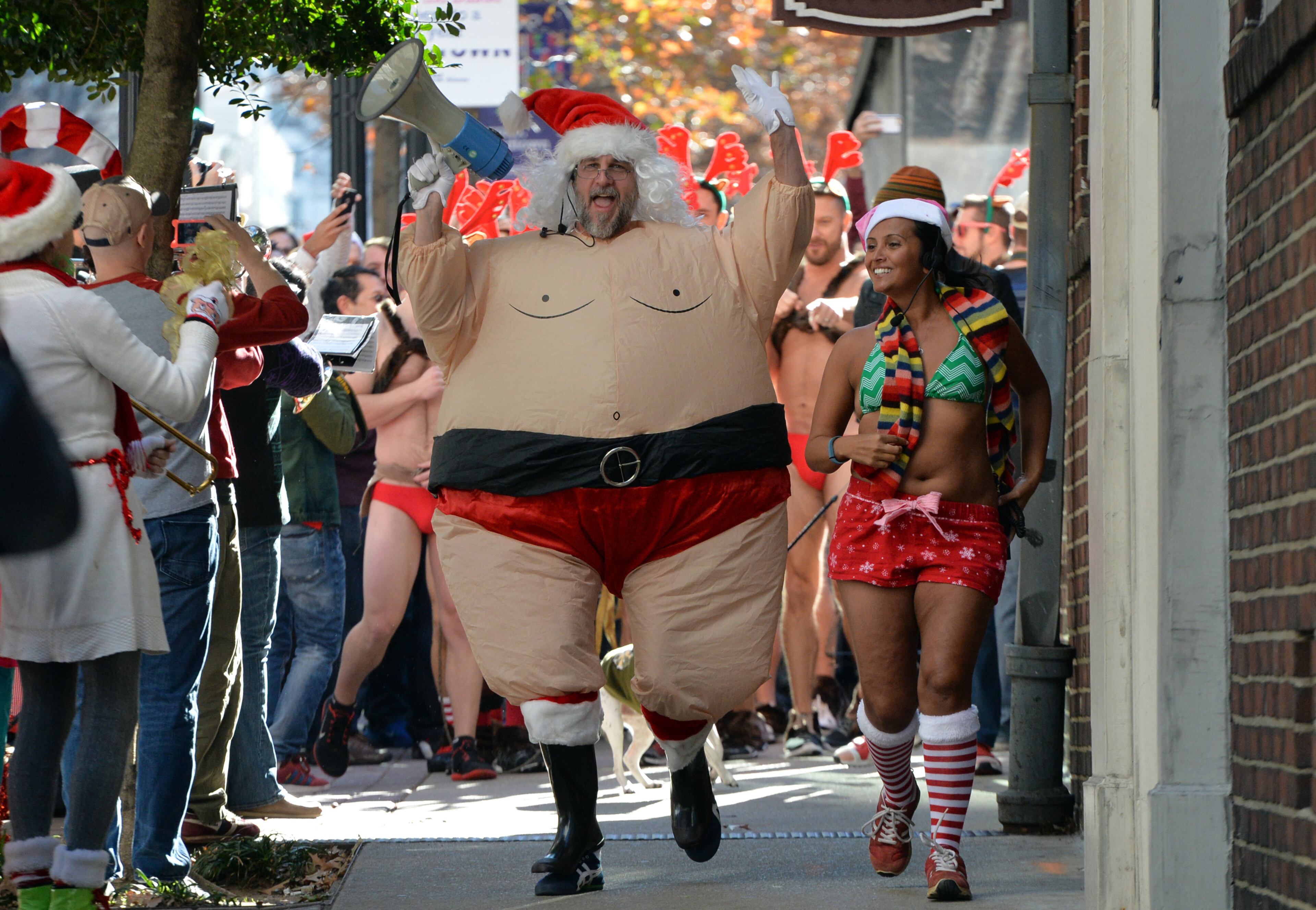 December 13, 2014 Atlanta - Sean Dixon-Parker (foreground left) and Tina Russo lead runners during Atlanta Santa Speedo Run on Saturday, December 13, 2014. The race is run to raise money during the 2014 Santa Speedo Run. These 'lightly' dressed Santas are fundraising to support Everybody Wins! Atlanta, a nonprofit devoted to improving children's reading skills that below current grade level. HYOSUB SHIN / HSHIN@AJC.COM