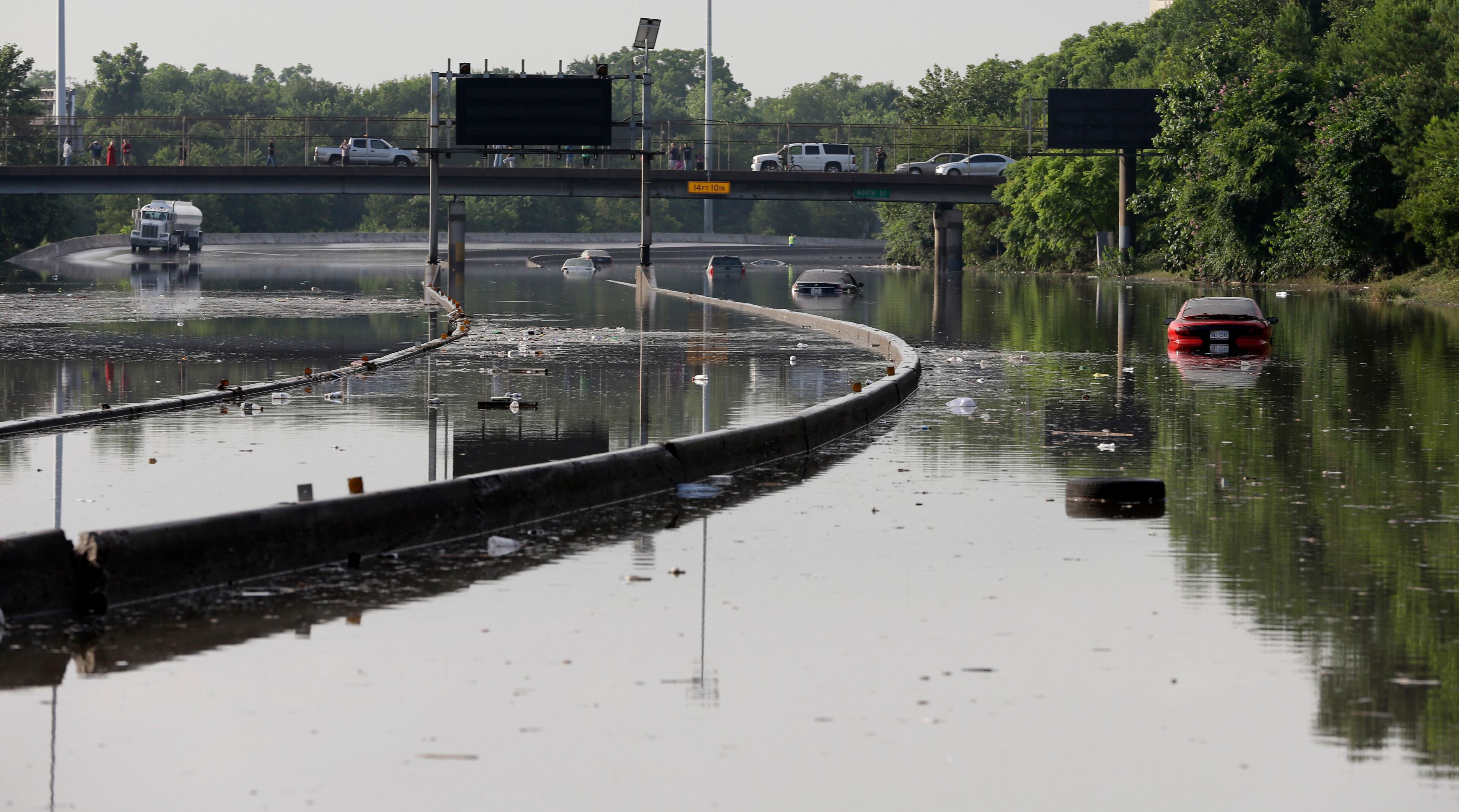 Cars remain stranded along a flooded section of Interstate 45 after heavy rains overnight in Houston, Tuesday, May 26, 2015. Several major highways are closed in the Houston area due to high water. (AP Photo/David J. Phillip)