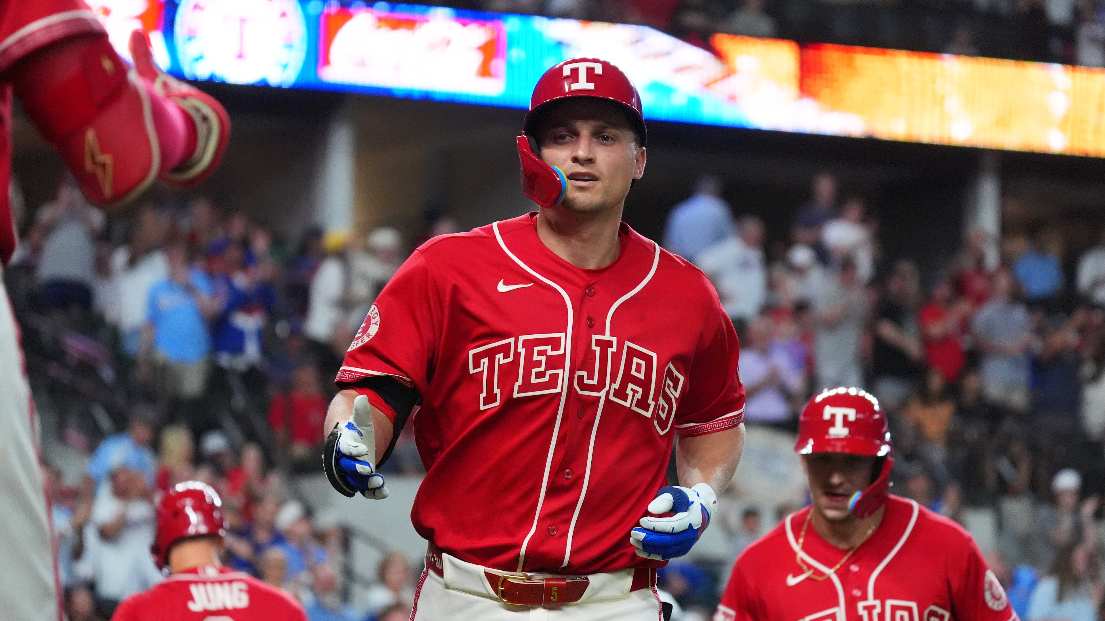 Texas Rangers' Corey Seager, center, jogs to the dugout after hitting a home run during the sixth inning of a baseball game against the Cleveland Guardians, Friday, June 5, 2026, in Arlington, Texas. (AP Photo/LM Otero)