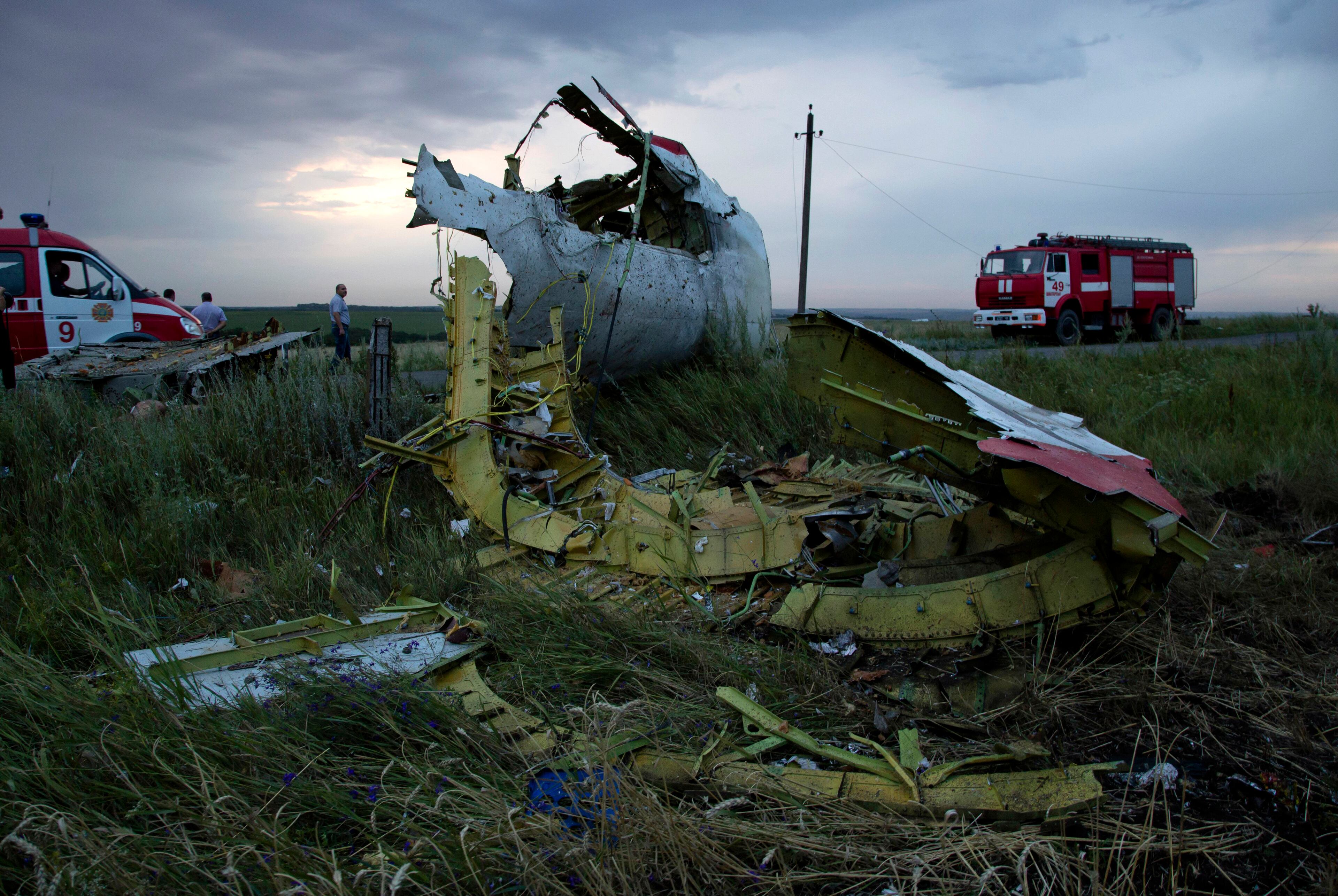 Fire engines arrive at the crash site of a passenger plane near the village of Grabovo, Ukraine, as the sun sets Thursday, July 17, 2014. Ukraine said a passenger plane carrying 295 people was shot down Thursday as it flew over the country, and both the government and the pro-Russia separatists fighting in the region denied any responsibility for downing the plane. (AP Photo/Dmitry Lovetsky)