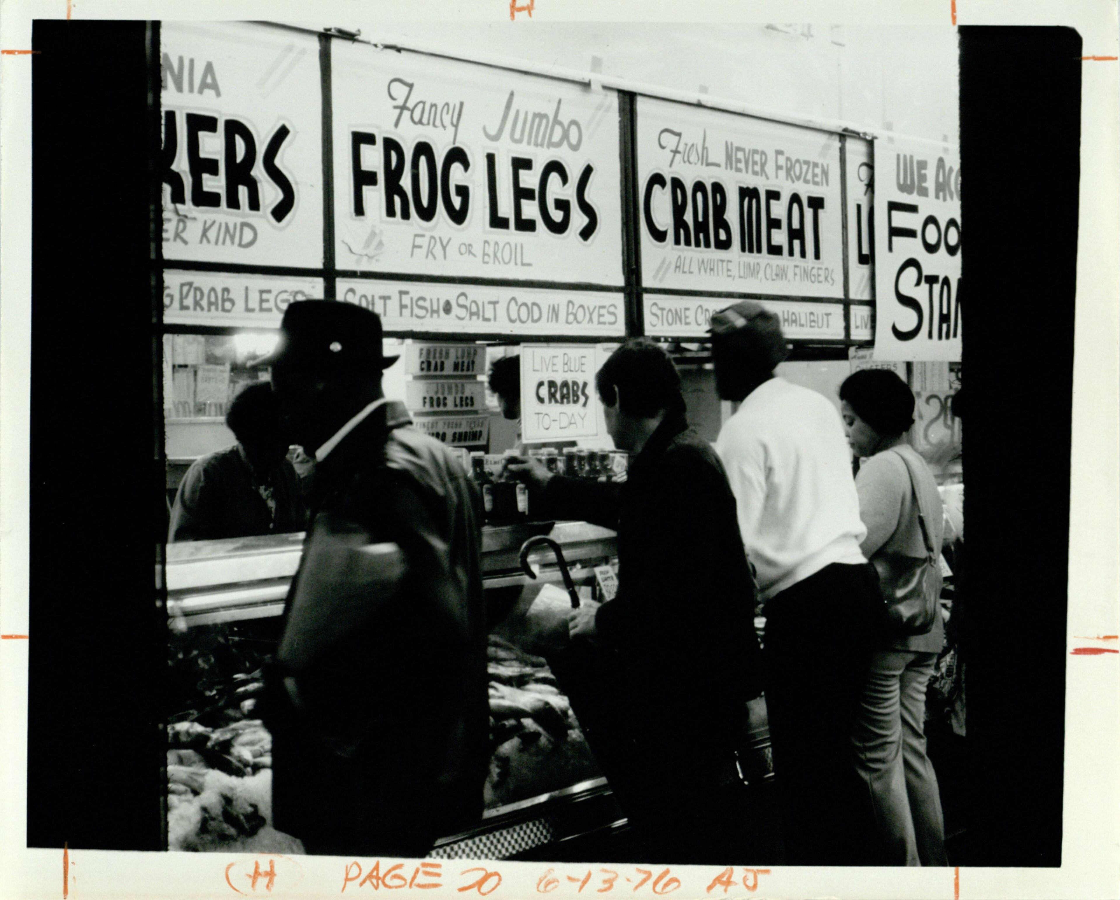 Customers line up at the seafood stall at the Sweet Auburn Market on June 13, 1976. William Wager/AJC