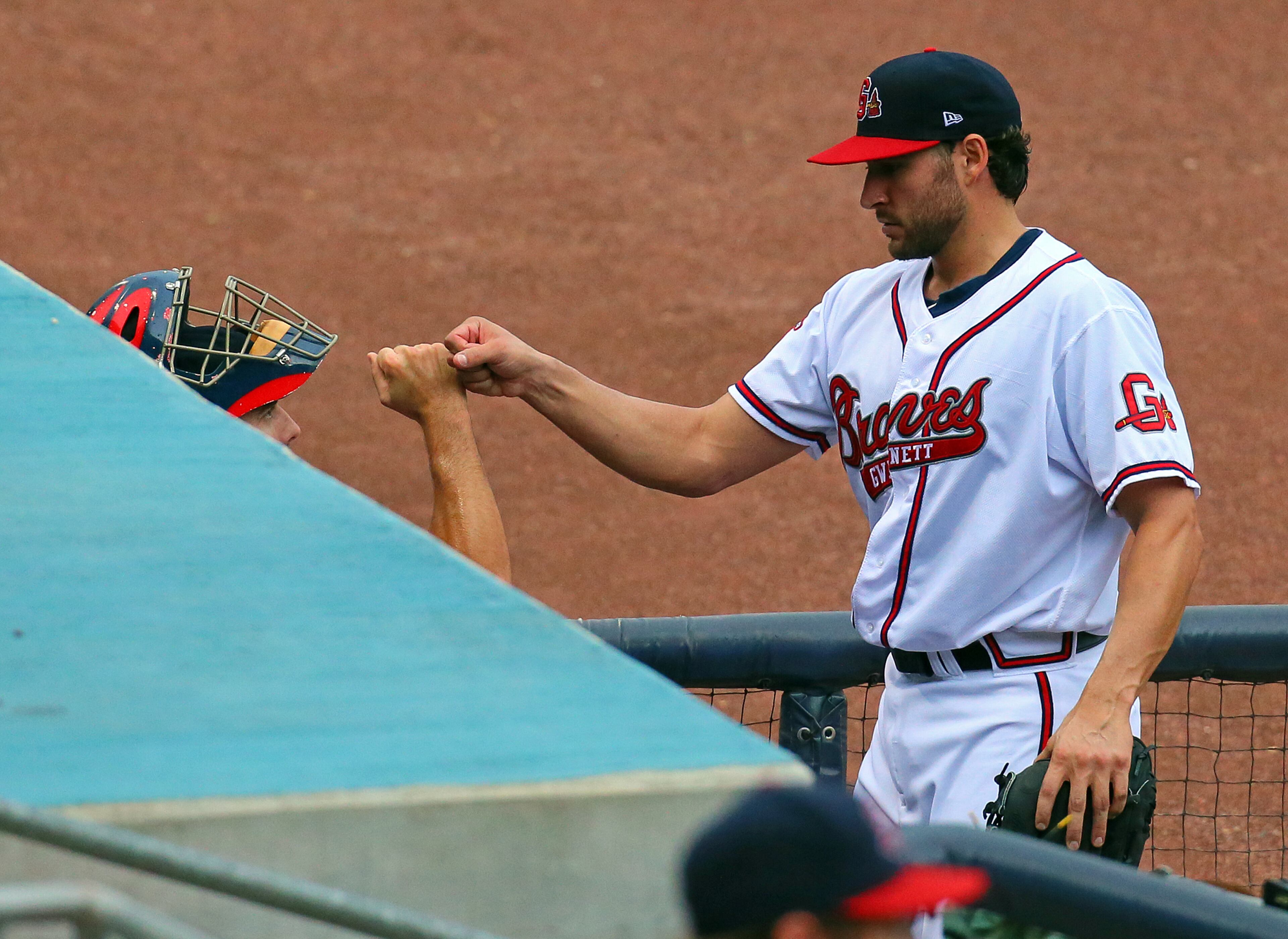 Brandon Beachy gets a fist bump from catcher Matt Pagnozzi after going three innings against the Norfolk Tides at Coolray Field on Tuesday, July 9, 2013, in Lawrenceville.