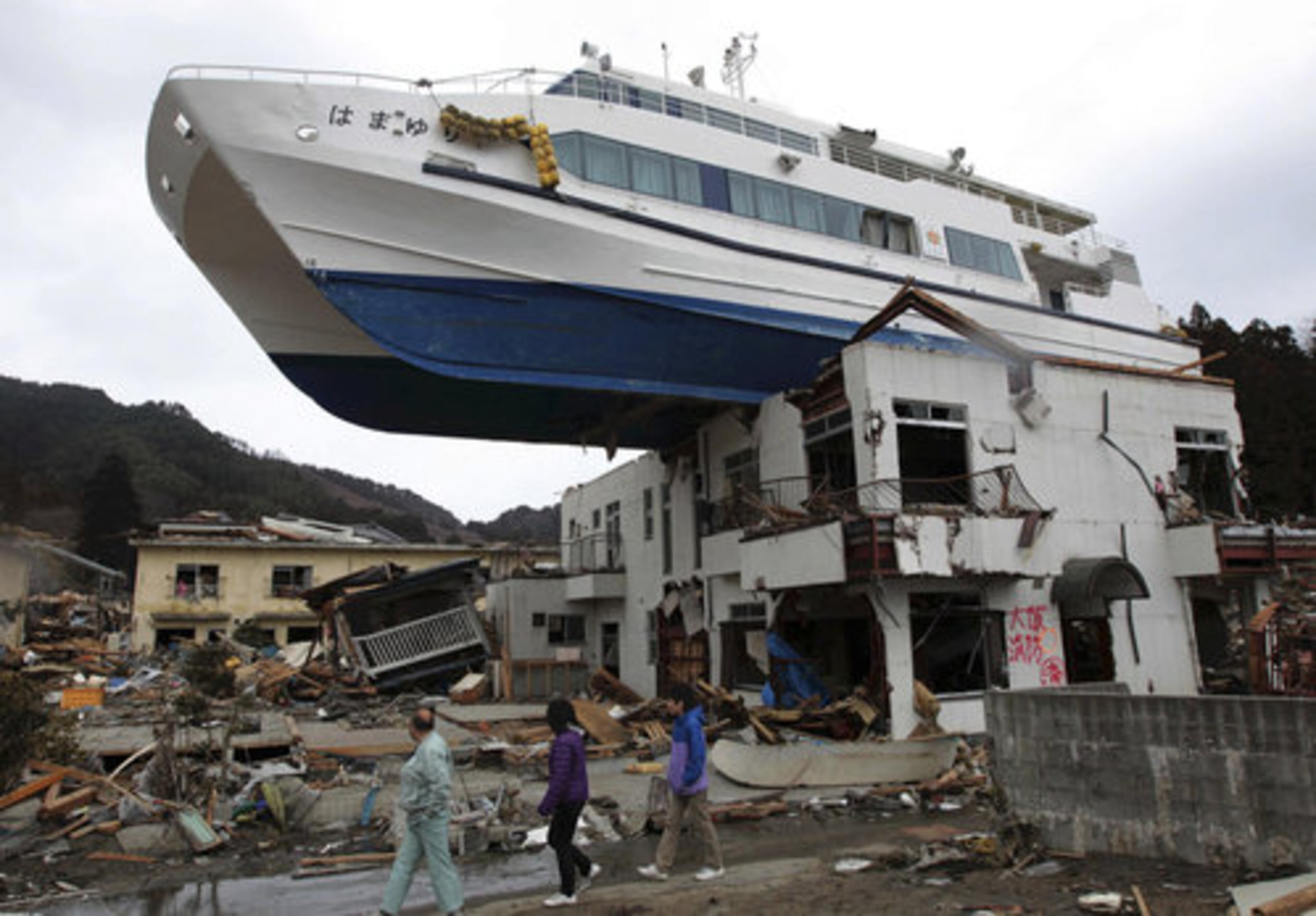 FILE -In this March 22, 2011 file photo, a boat sits atop a building in Otsuchi, Iwate Prefecture, Japan, following the March 11 earthquake and tsunami which devastated a vast area of northeastern Pacific coast of Japan.