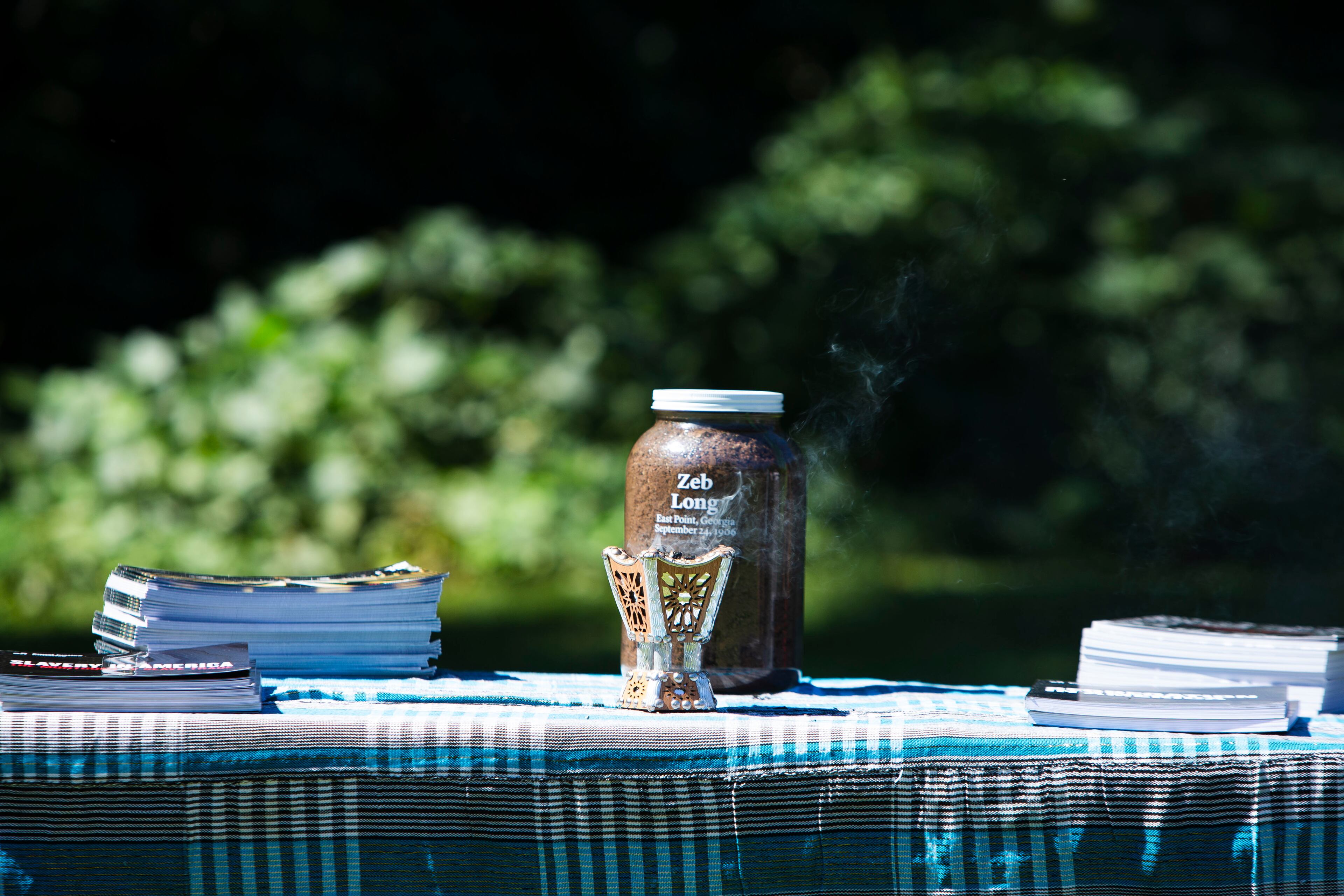 On a table sits a jar of soil from the lynching site, which was collected in February by the Montgomery, Alabama, nonprofit Equal Justice Initiative. On Saturday, September 24, 2022, at Sumner Park in East Point, a historical marked was unveiled. CHRISTINA MATACOTTA FOR THE ATLANTA JOURNAL-CONSTITUTION
