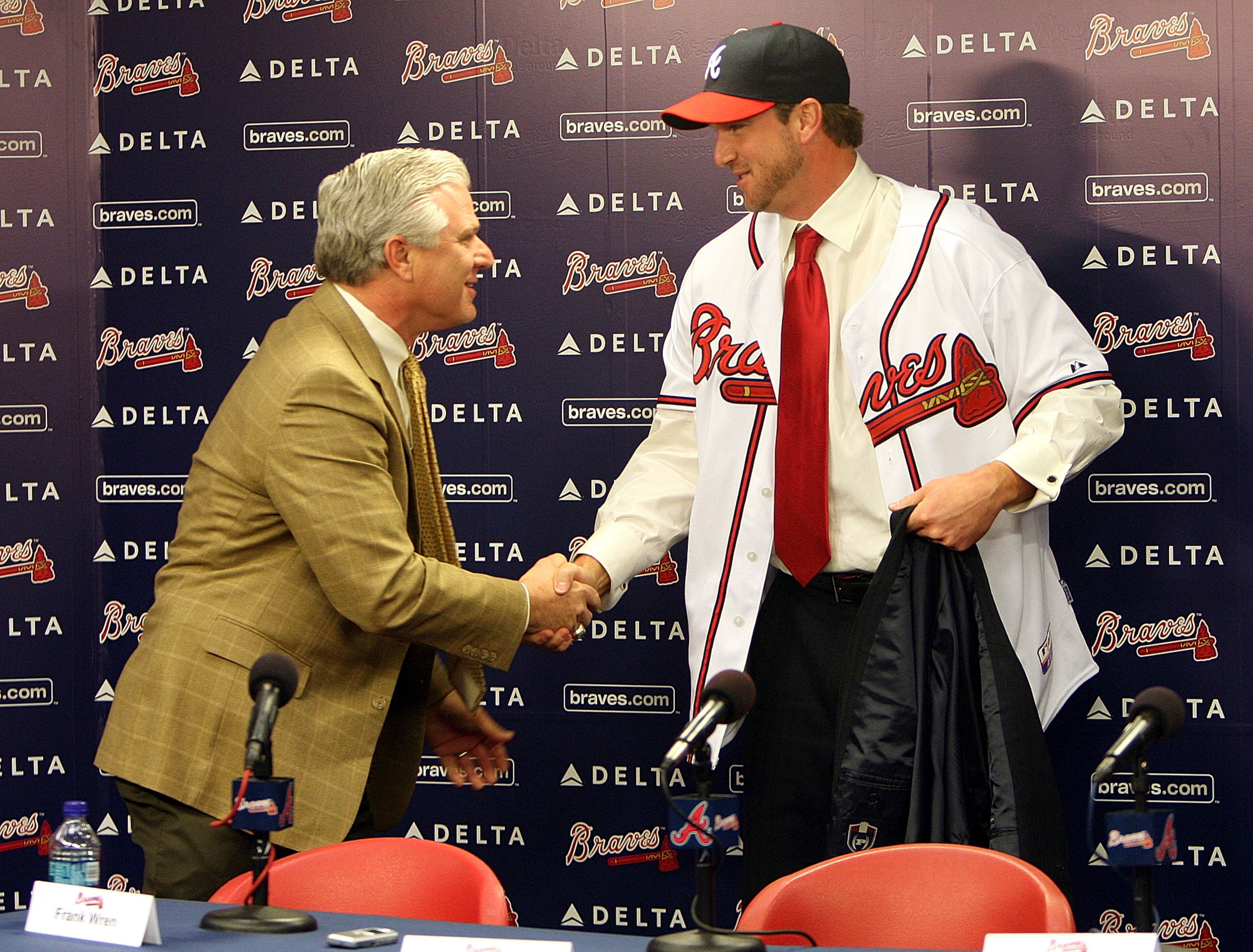 Don't do it handshake: Braves GM Frank Wren (left) welcomes Derek Lowe after signing the free agent pitcher.