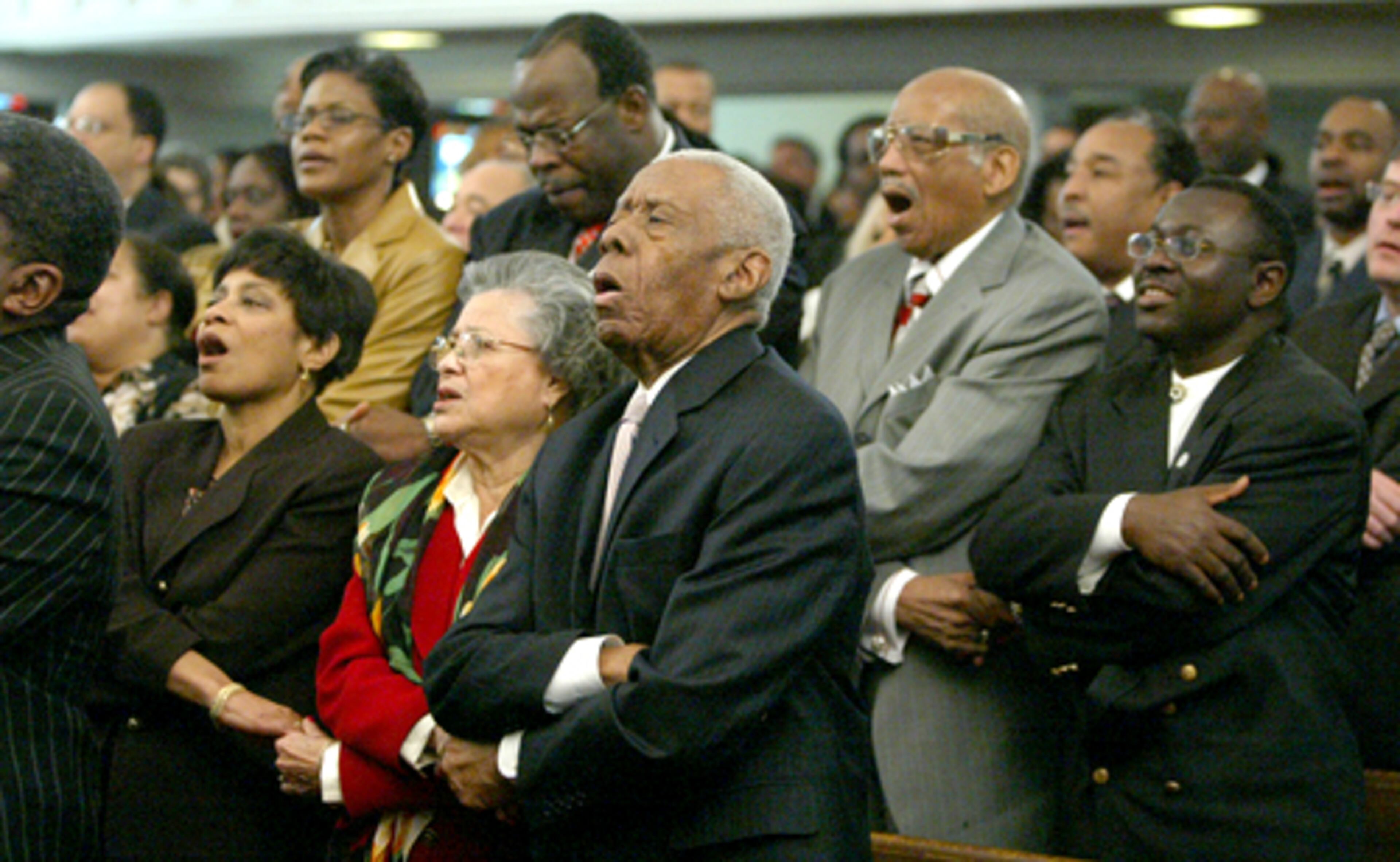 Hill encouraged the creation of programs in black colleges, including Clark Atlanta University, to teach business and entrepreneurship to new generations of young African-American men and women. He also worked to help young people acquire venture capital for new businesses. Here, he joins hands with Azira to sing " We Shall Overcome" during the 77th birthday observance on Dr. Martin Luther King.