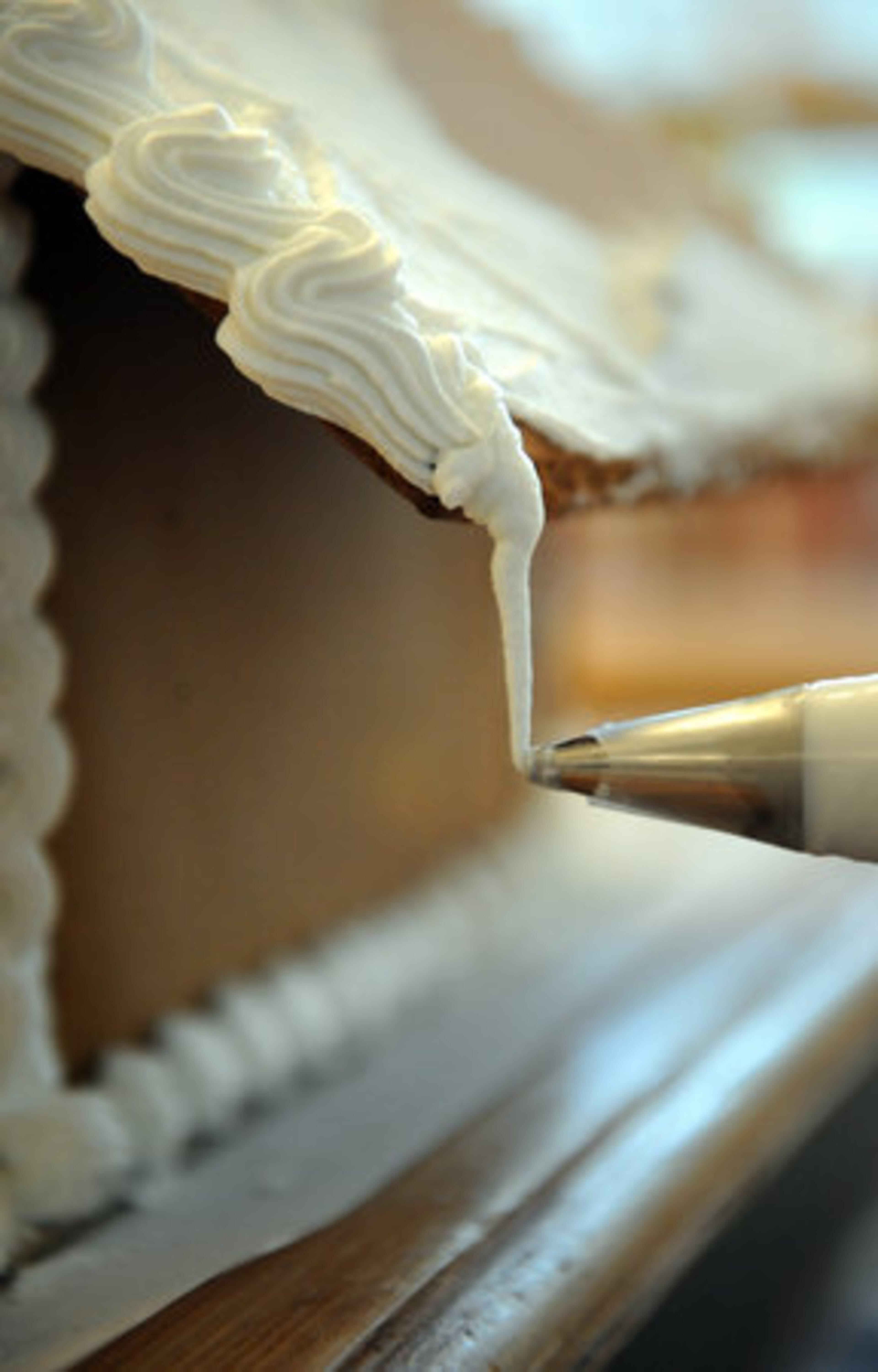 1. Prepare the royal icing (see accompanying story for the recipe), which is what you should use for decorating and putting your cake together. Use a meringue powder instead of raw egg whites. There's an easy recipe inside the canister. It's best to make the icing a little looser (by adding a few drops more water) for two reasons - your icing will not dry too hard and it will be easier for little hands to pipe (see photo). Keep the icing covered HYOSUB SHIN / HSHIN@AJC.COM