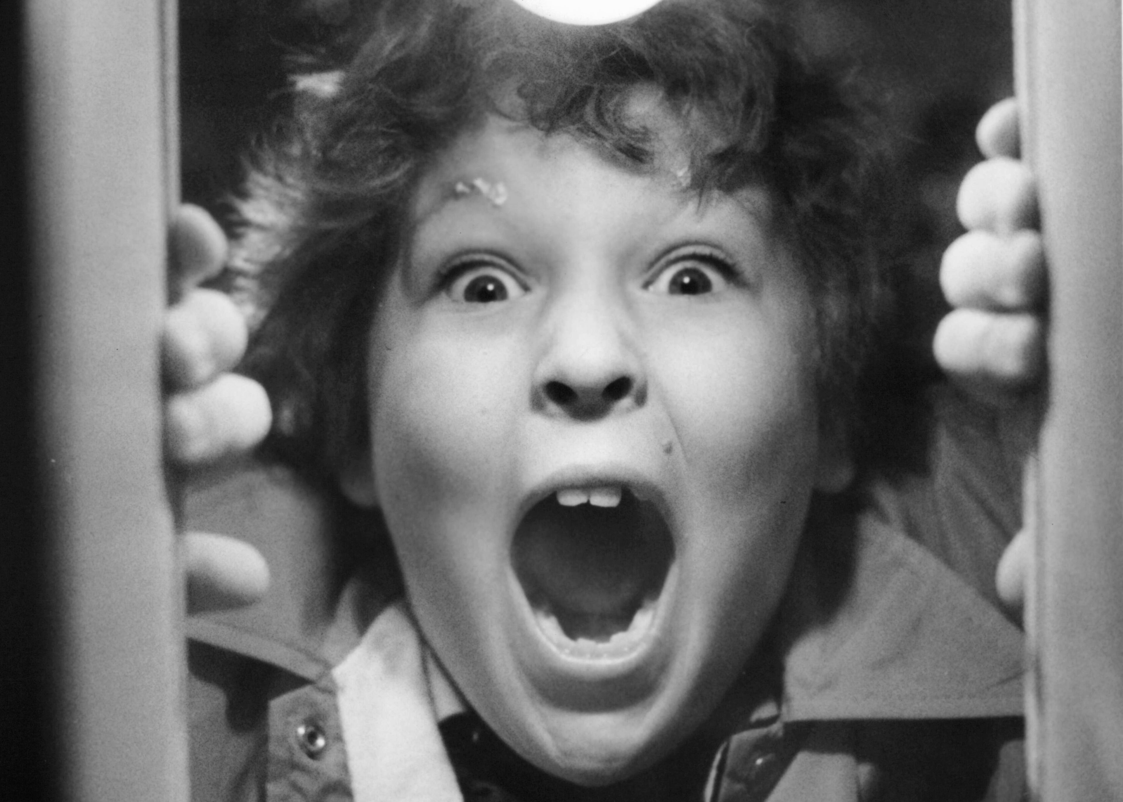 Jeff Cohen played 'Chunk'. This photo is from 1985 - Jeff Cohen shouting through a hole in the door in a scene from the film 'Goonies', 1985. (Photo by Warner Brothers/Getty Images)