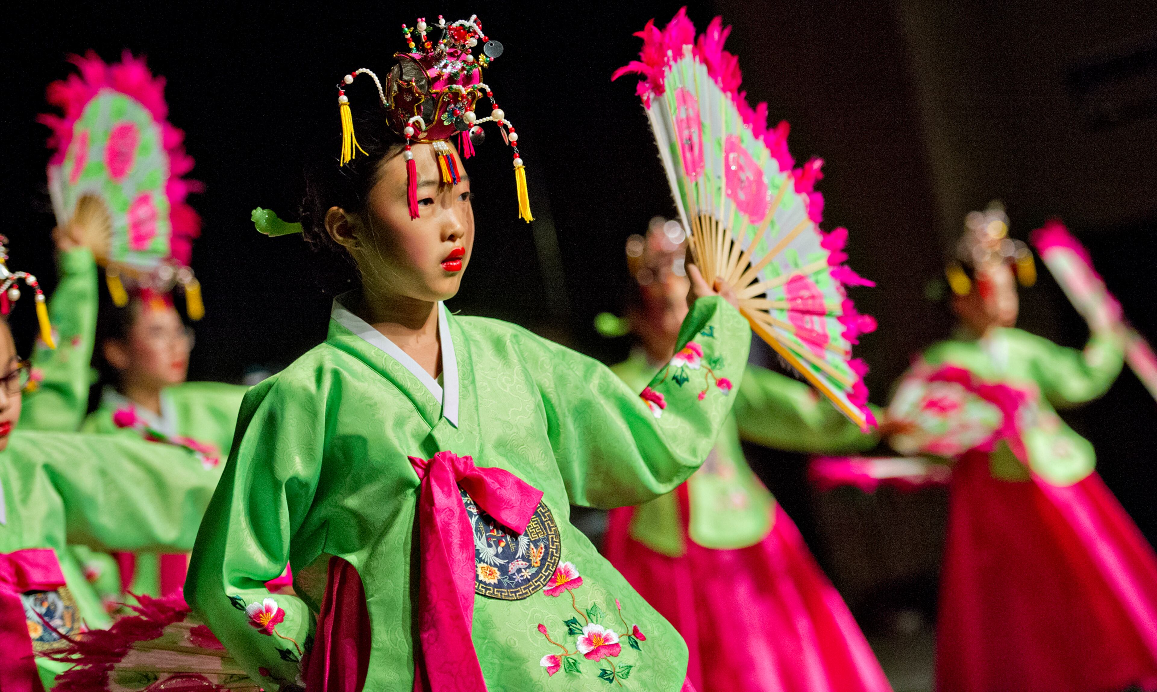 Grace Cheon (center) performs on stage during the holiday dinner.