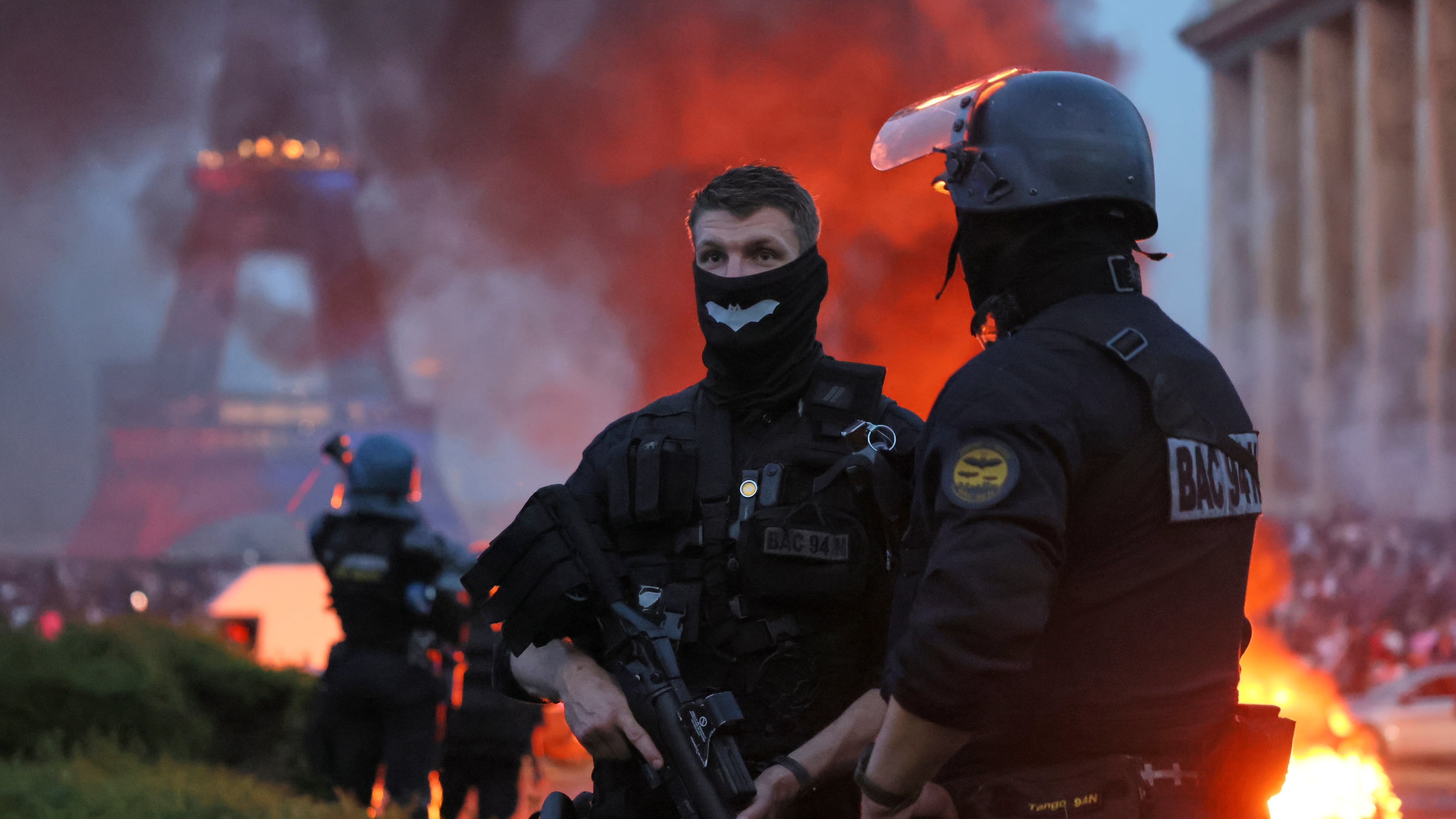 A car burns and fireworks explode as police watch PSG supporters celebrate in Paris, Saturday, May 30, 2026 after the Champions League final soccer match between Paris Saint-Germain and Arsenal that's being played in Budapest, PSG won the game. (AP Photo/Thomas Padilla)