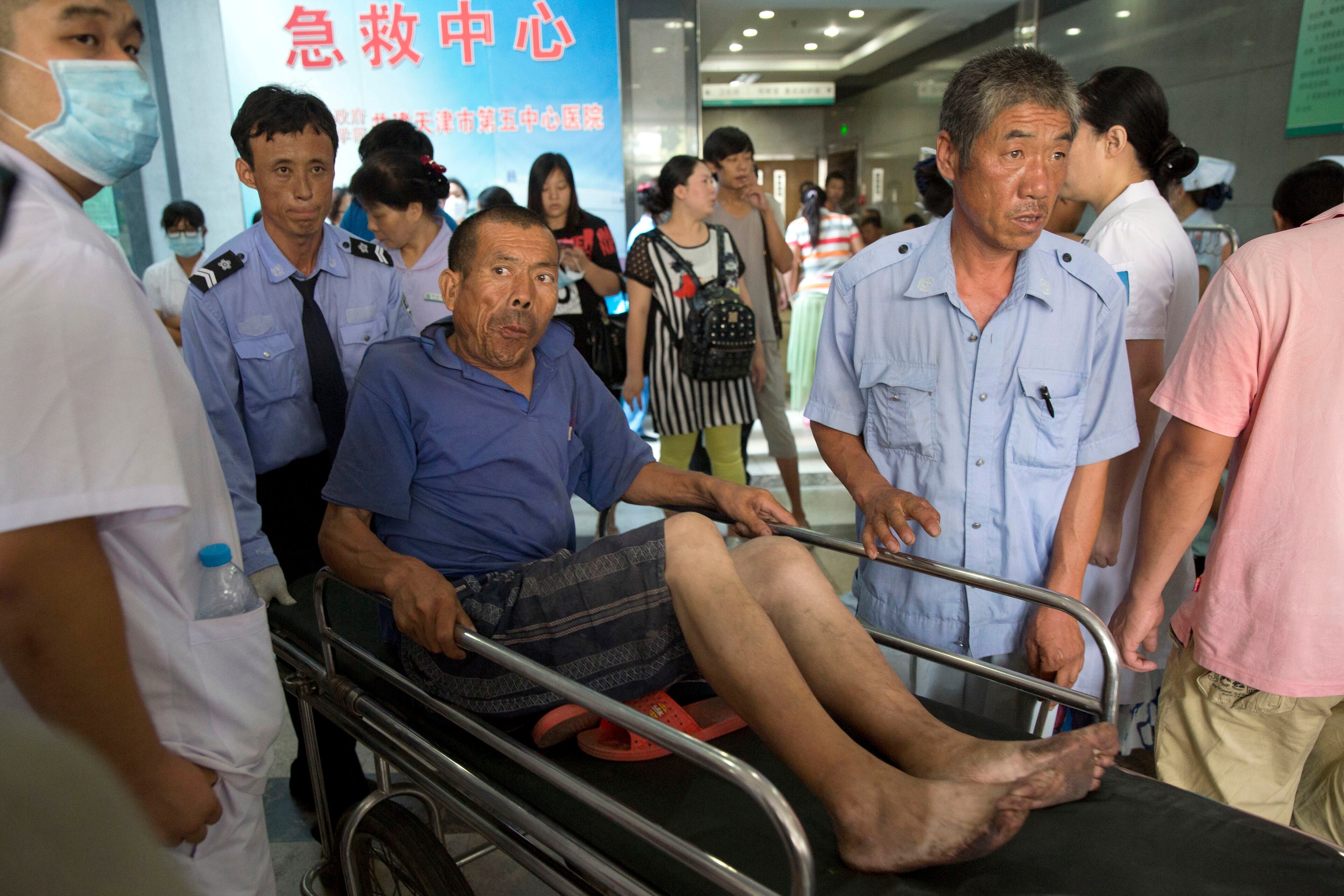 A man is pushed through an emergency ward at a hospital receiving victims of an explosion in northeastern China's Tianjin municipality Aug. 13, 2015.