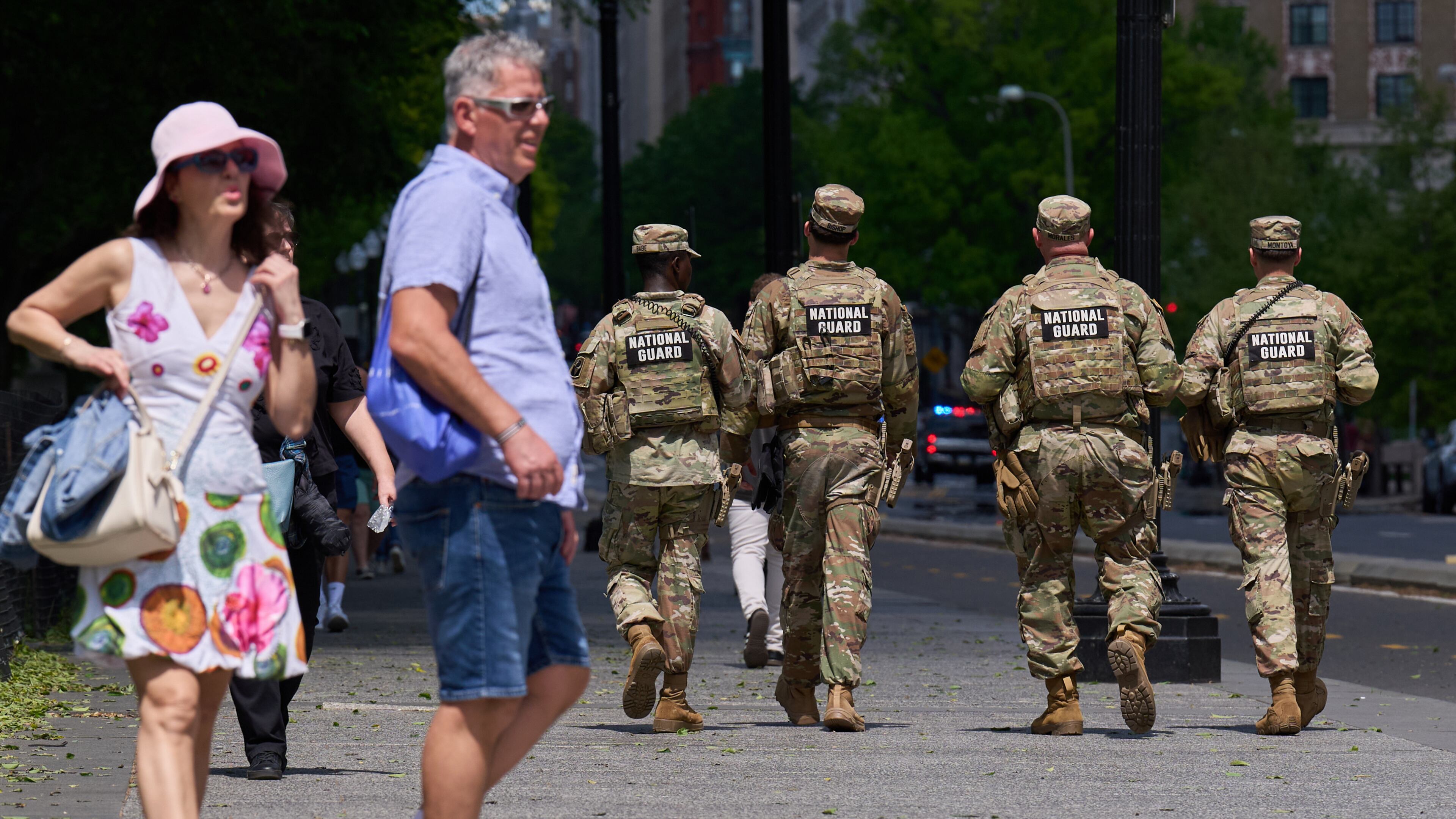Members of the Florida National Guard pass by tourists on a sidewalk Friday April 17, 2026, in Washington. (AP Photo/Jacquelyn Martin)